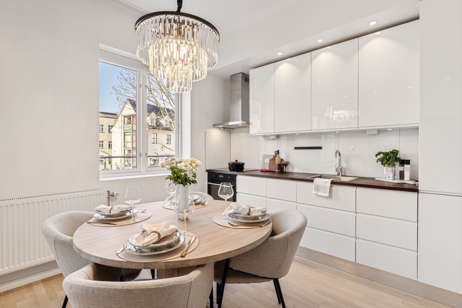 Tidløst kjøkkeninnredning med glatte fronter og oljet benkeplate med kjøkkenvask. Galleribilde