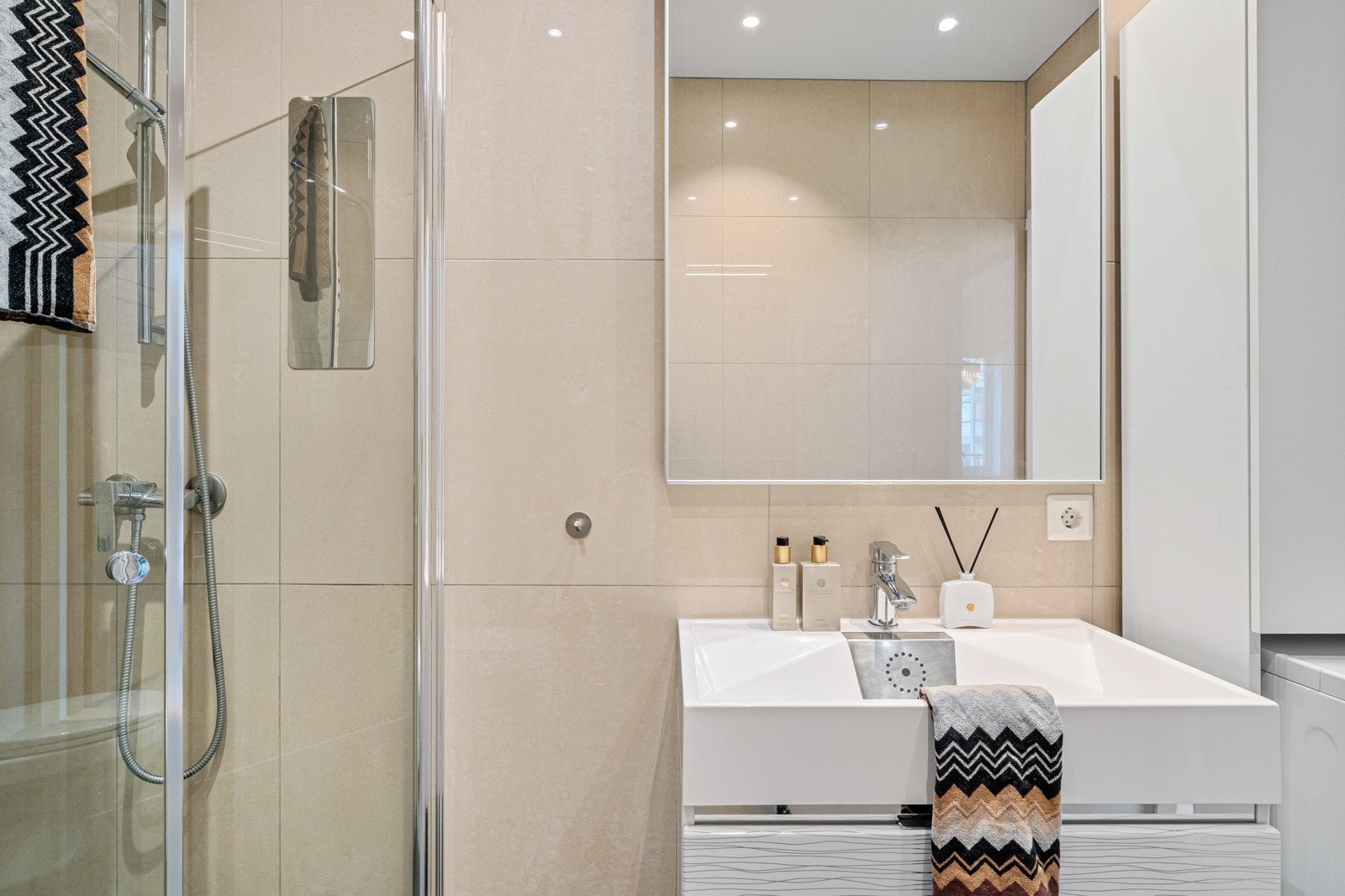 Badet er utstyrt m foldedører i dusj, vegghengt toalett og opplegg for vaskemaskin. Galleribilde