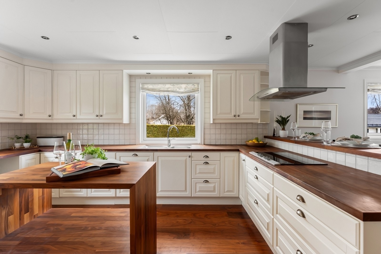 Kjøkkeninnredning fra 2005 med benkeplater av heltre, profilerte fronter og flislagt backsplash Galleribilde