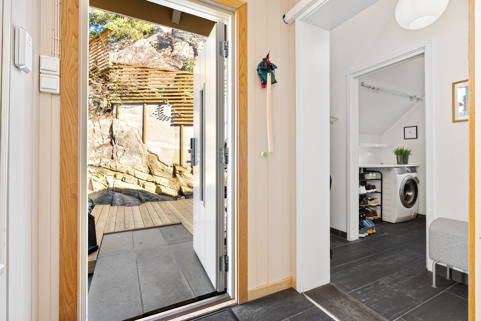 Det er fliser i entre og praktisk garderobe med garderoberom rett ved siden av inngangen Galleribilde