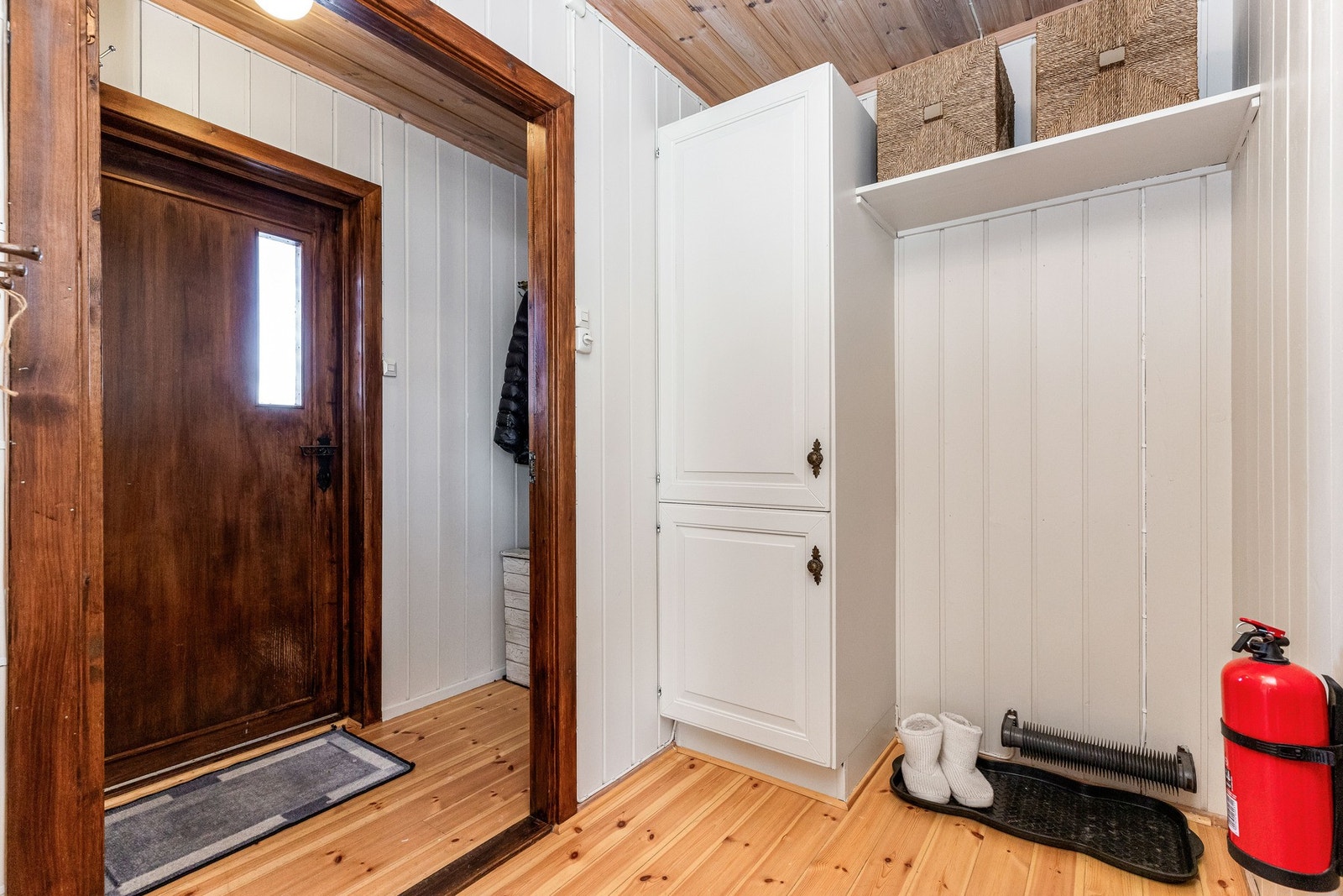 Mellomgang med garderobeskap og plassbygd hylle for yttertøy og sko. Hengslene på garderobeskapet i gangen er defekt Galleribilde