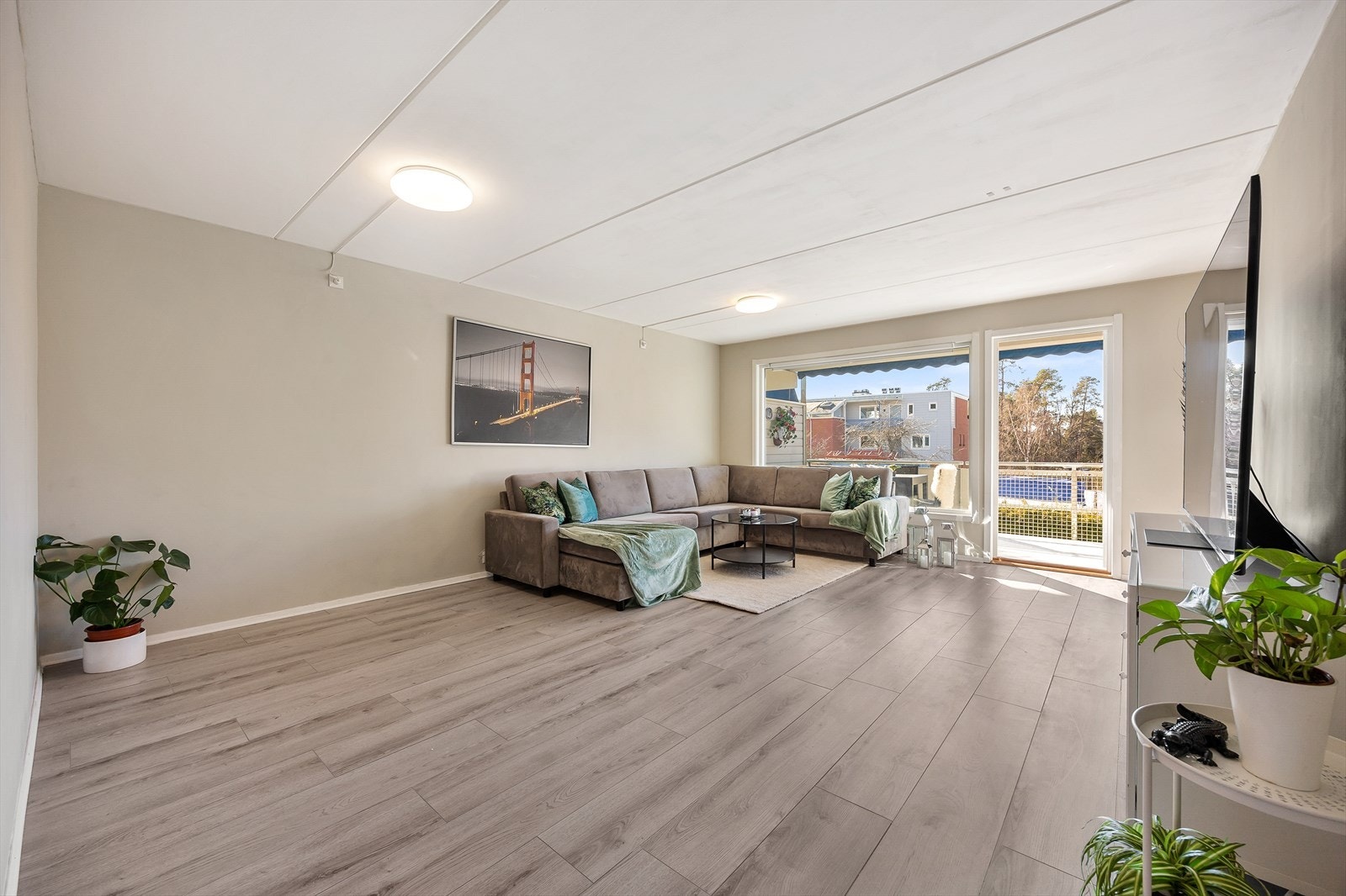 Med gjennomgående løsning og store vinduer oppleves stuen som lys og luftig Galleribilde