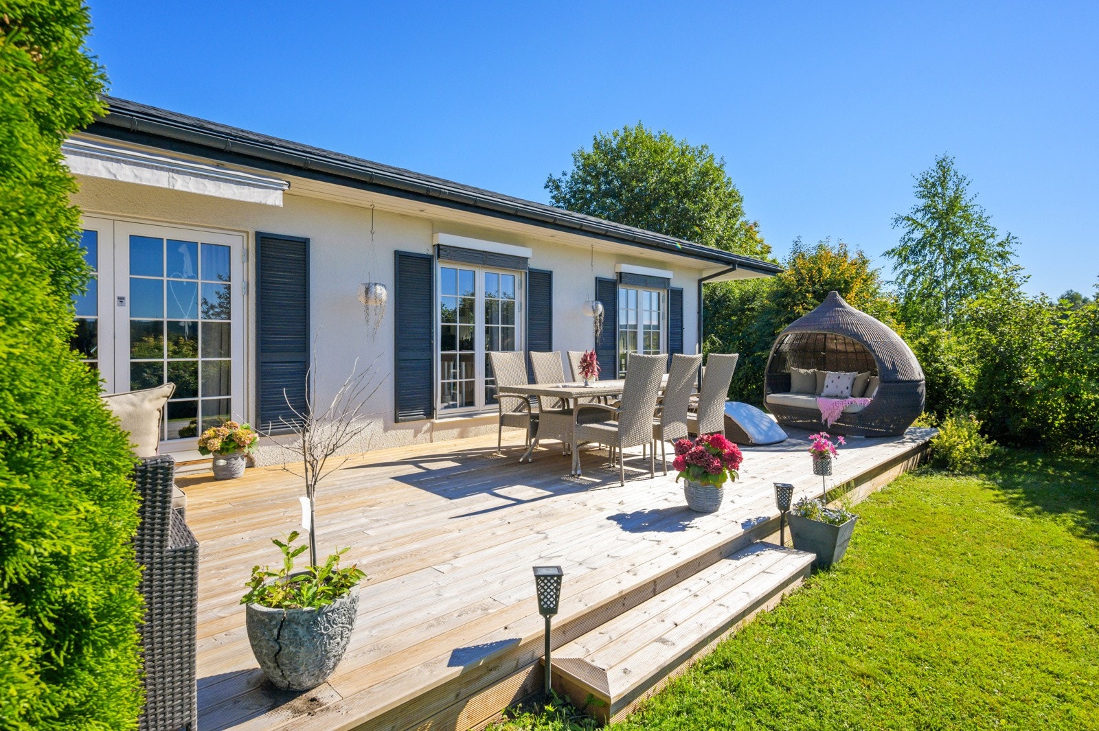 Fra stuen har man adkomst ut til den fine terrassen og hagen. Galleribilde