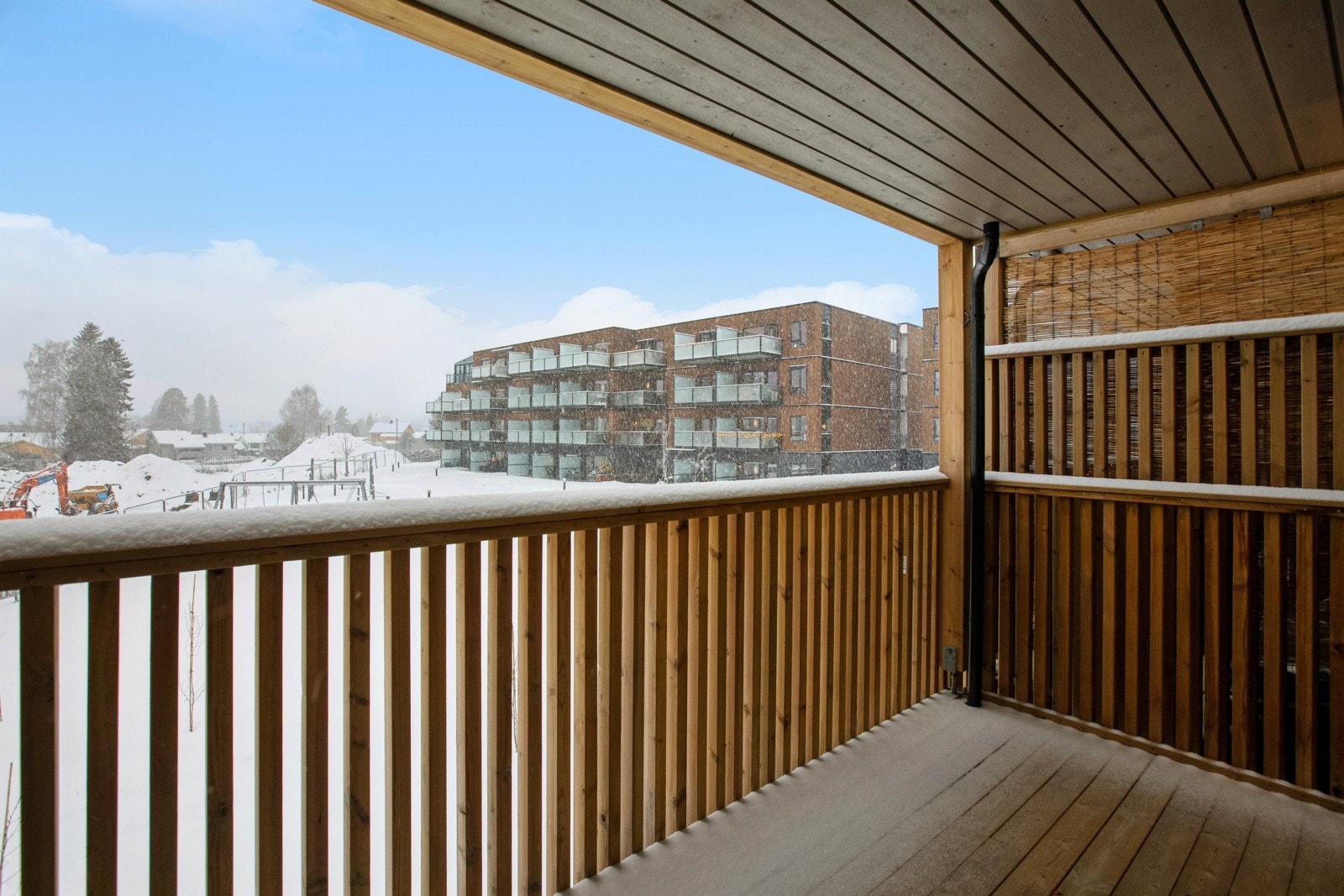 Balkongen ligger skjermet til med utsikt over fellesområdene. Galleribilde