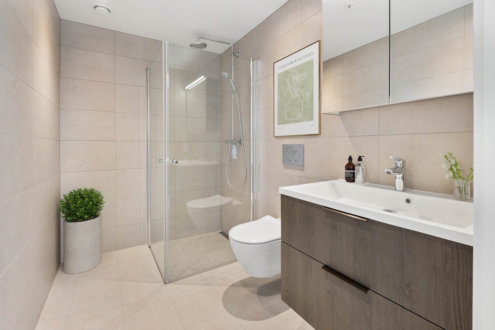 De to badene har moderne fliser, elektrisk gulvvarme og stilren innredning fra Sigdal (Bark 2.0) med romslige skuffer og heldekkende vask. Vegghengt toalett fra Villeroy & Boch og dusjhjørne med innfellbare dører i krom gir et eksklusivt preg. Galleribilde