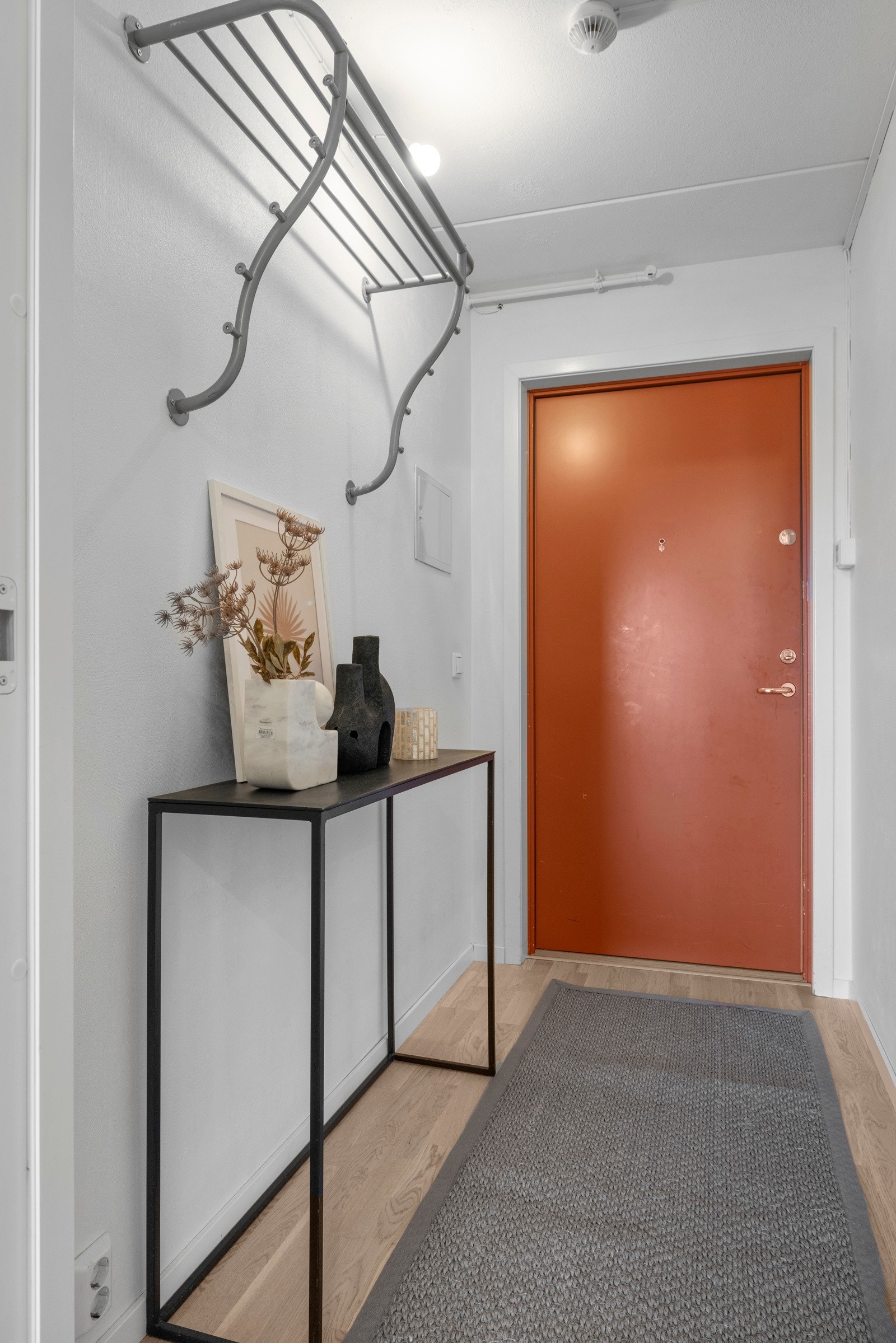 Entréen er både innbydende og praktisk, med plass til sittebenk, skoskap eller kommode, alt etter behov. Dørcalling er installert for enkel kommunikasjon med besøkende. Galleribilde