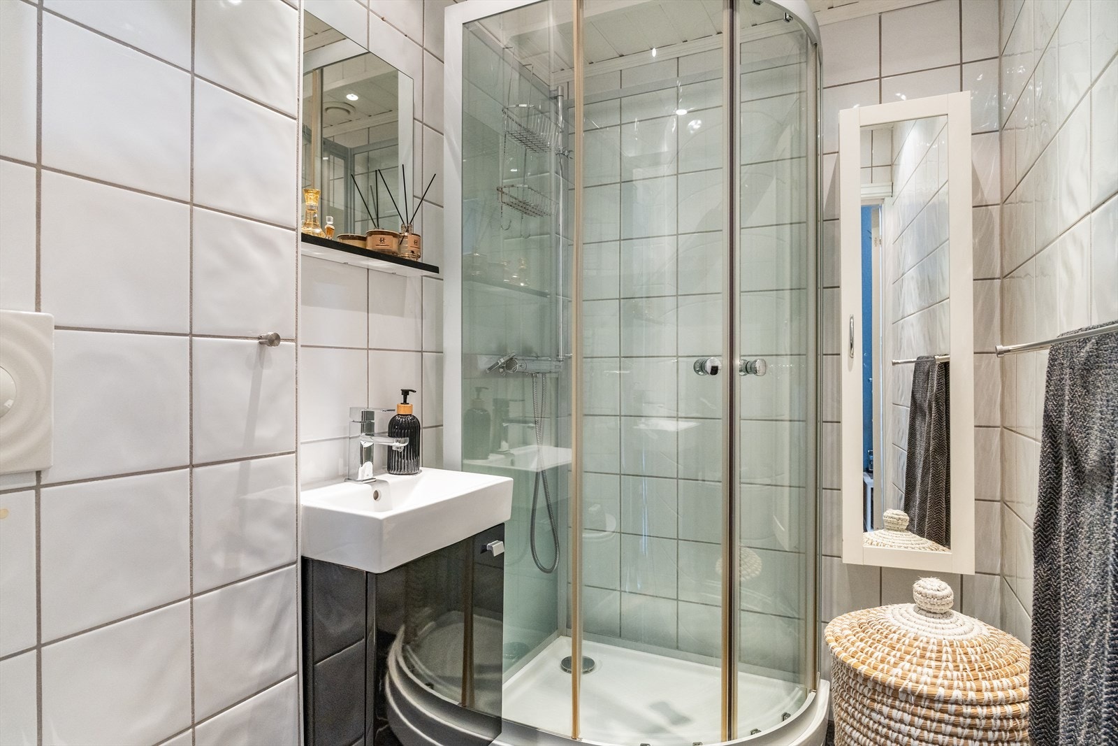 Pent helfliset bad med hvite fliser på vegg og mørke på gulv. Varmekabler i gulv. Galleribilde