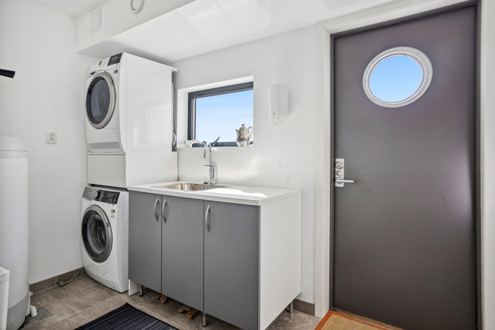 Praktisk og pent vaskerom. Det er lagt fliser på gulv med varme og man har direkte utgang til uteområde. Galleribilde