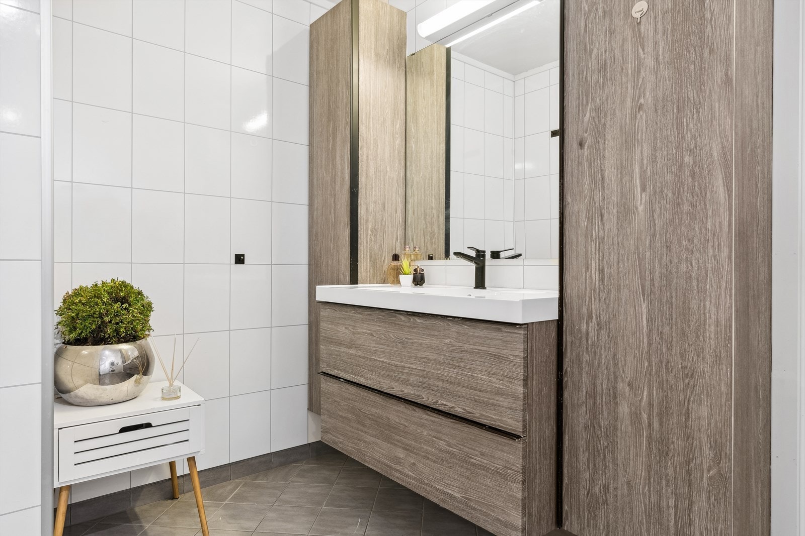 Innredningen består av servant med skuffer under, to høyskap og speil på vegg Galleribilde