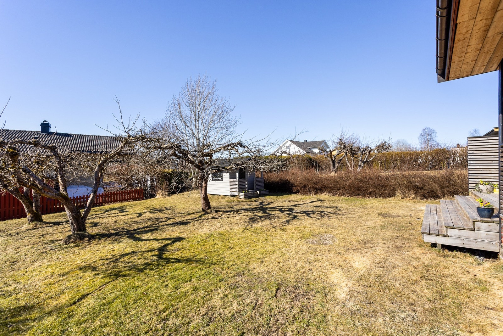Tomten tilhørende eiendommen er pent opparbeidet med gressplen, prydebusker, frukttrær og solrike uteplasser. Hele hagen er rammet inn med hekk og gjerder, og gir en trygg og fin boltreplass. Galleribilde