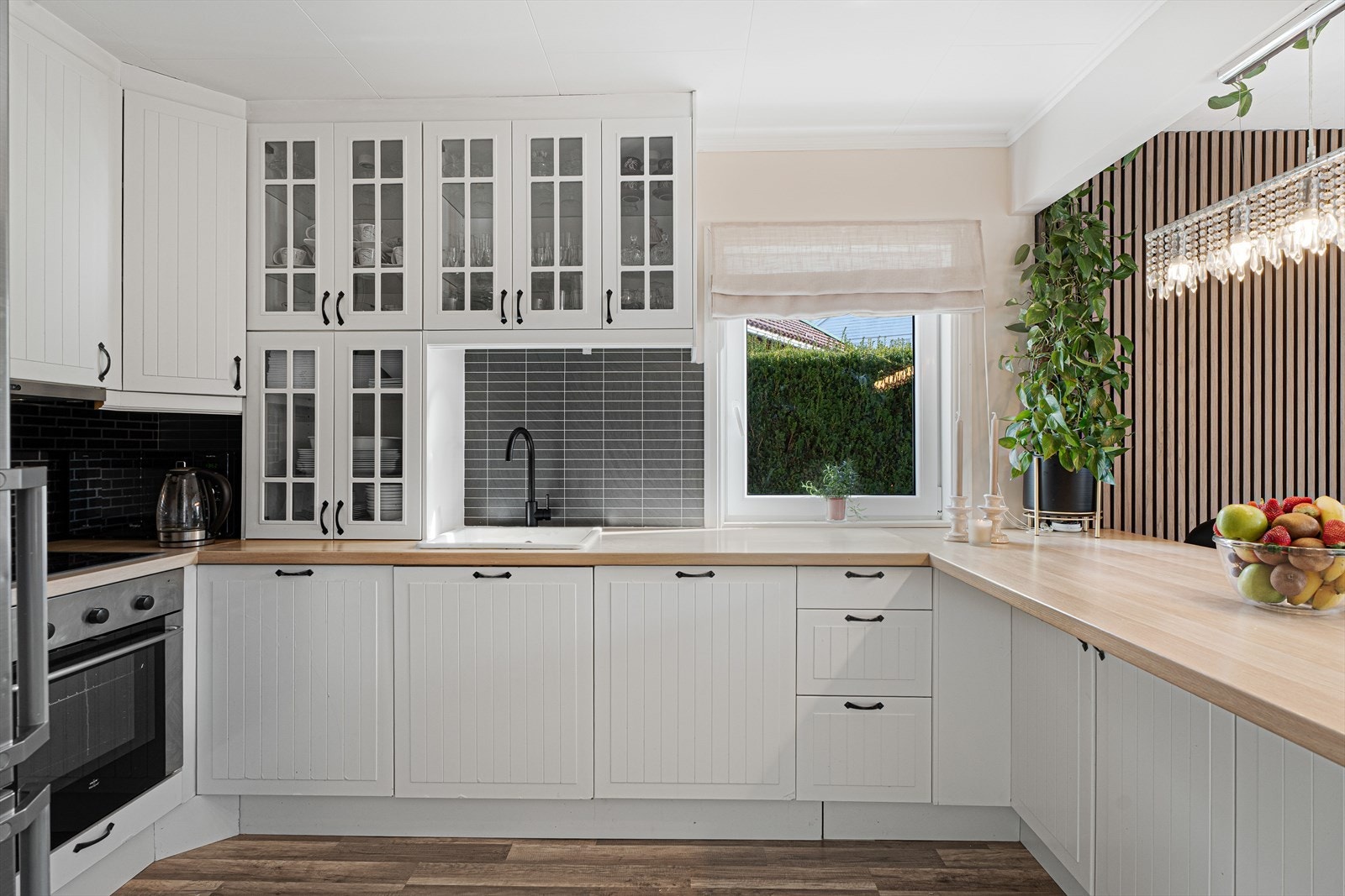 Kjøkkenet har profilerte fronter og laminat benkeplate Galleribilde