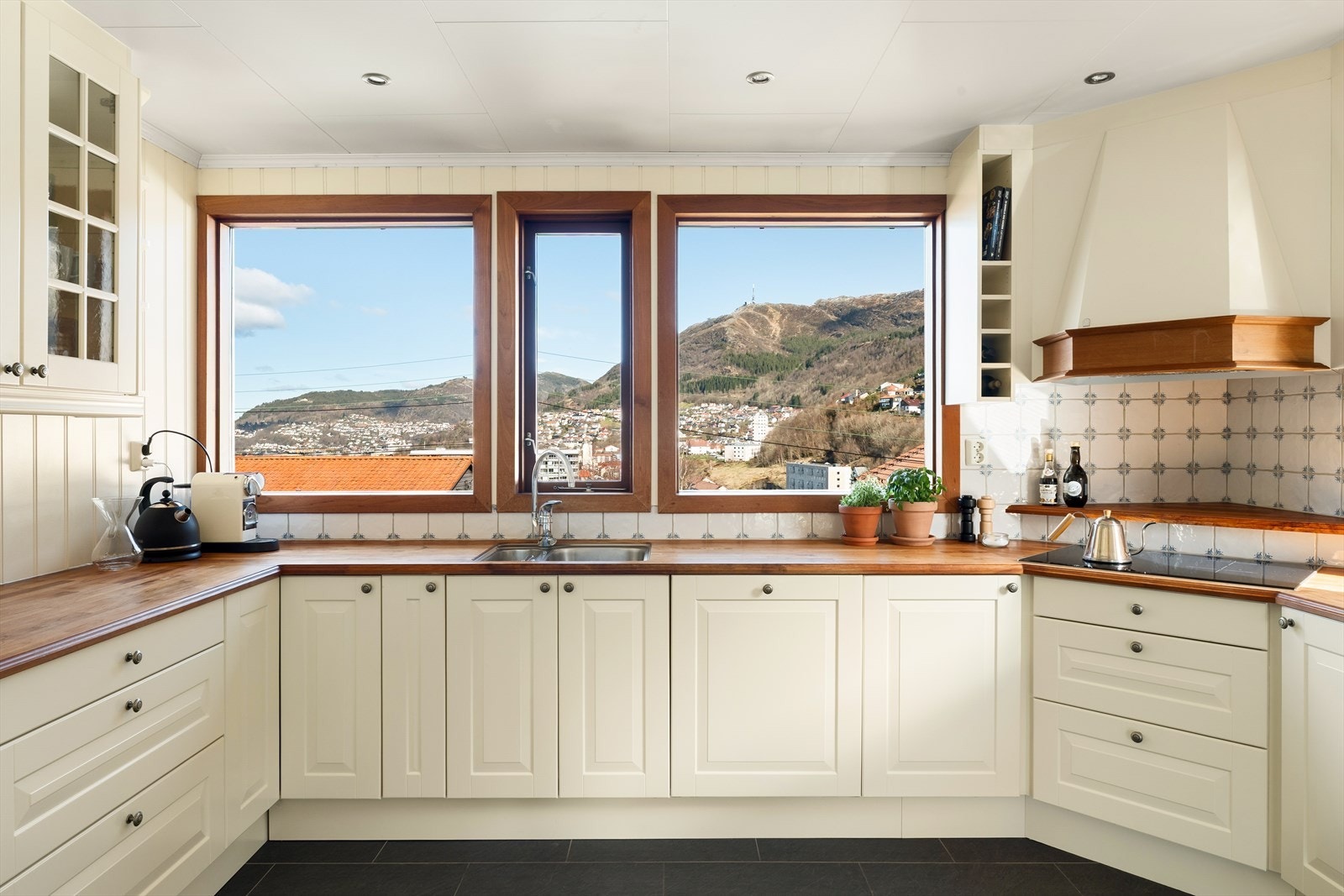 Innredningen har en tidløs utførelse med lyse, profilerte fronter og benkeplate av teak. Galleribilde