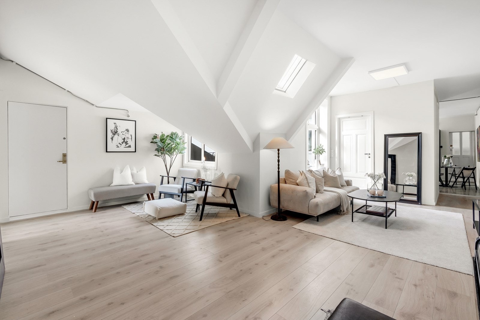 Leiligheten har store vindusflater som slipper inn naturlig lys. God plass til generøs sofagruppe Galleribilde