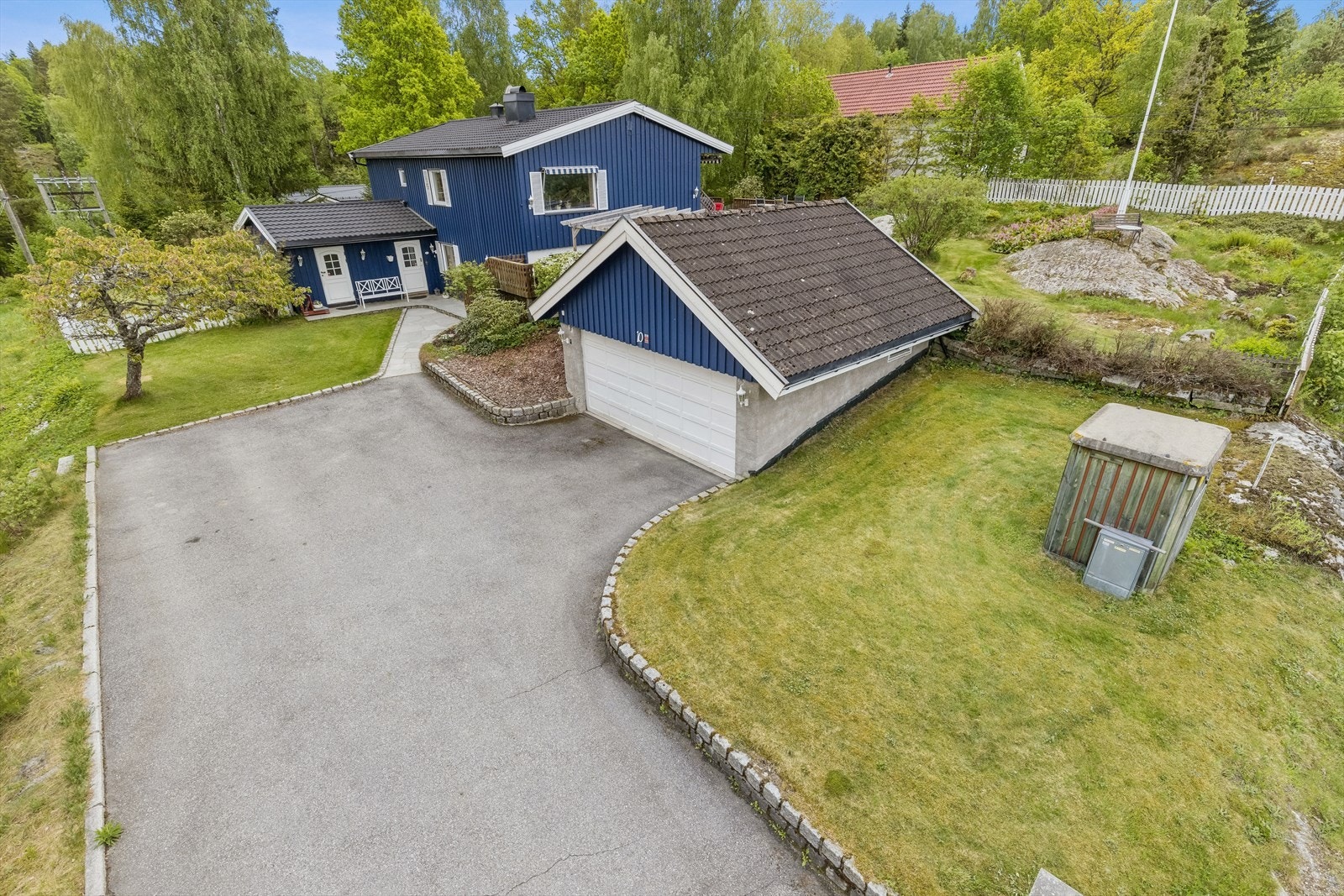 Stor tomt, romslig gårdsplass, pent opparbeidet med plener og noe naturtomt. Galleribilde