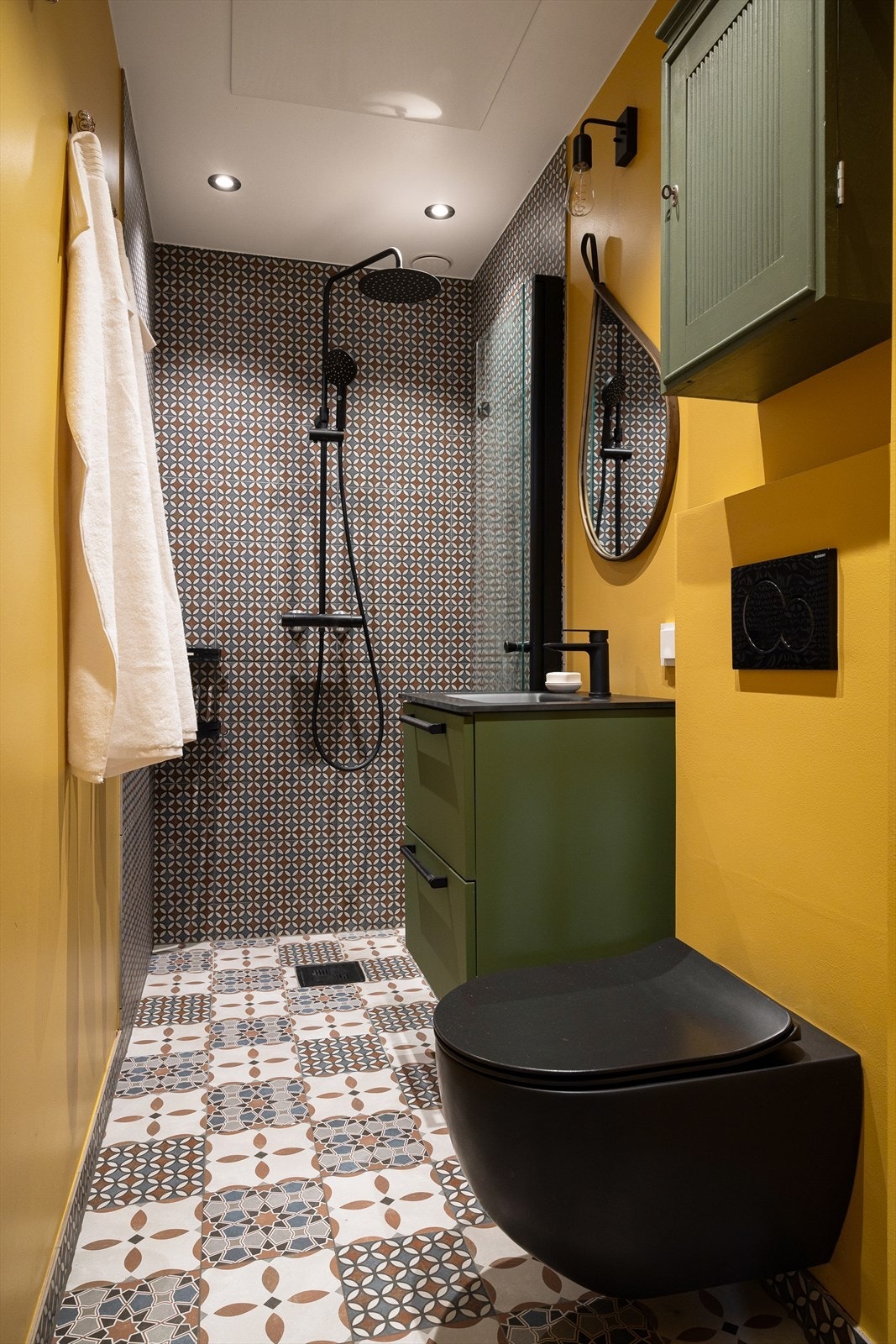 Badet har en stilig utførelse bestående av både malte veggflater og fliser med mønster, i tillegg til flislagt gulv med behagelige varmekabler. Galleribilde