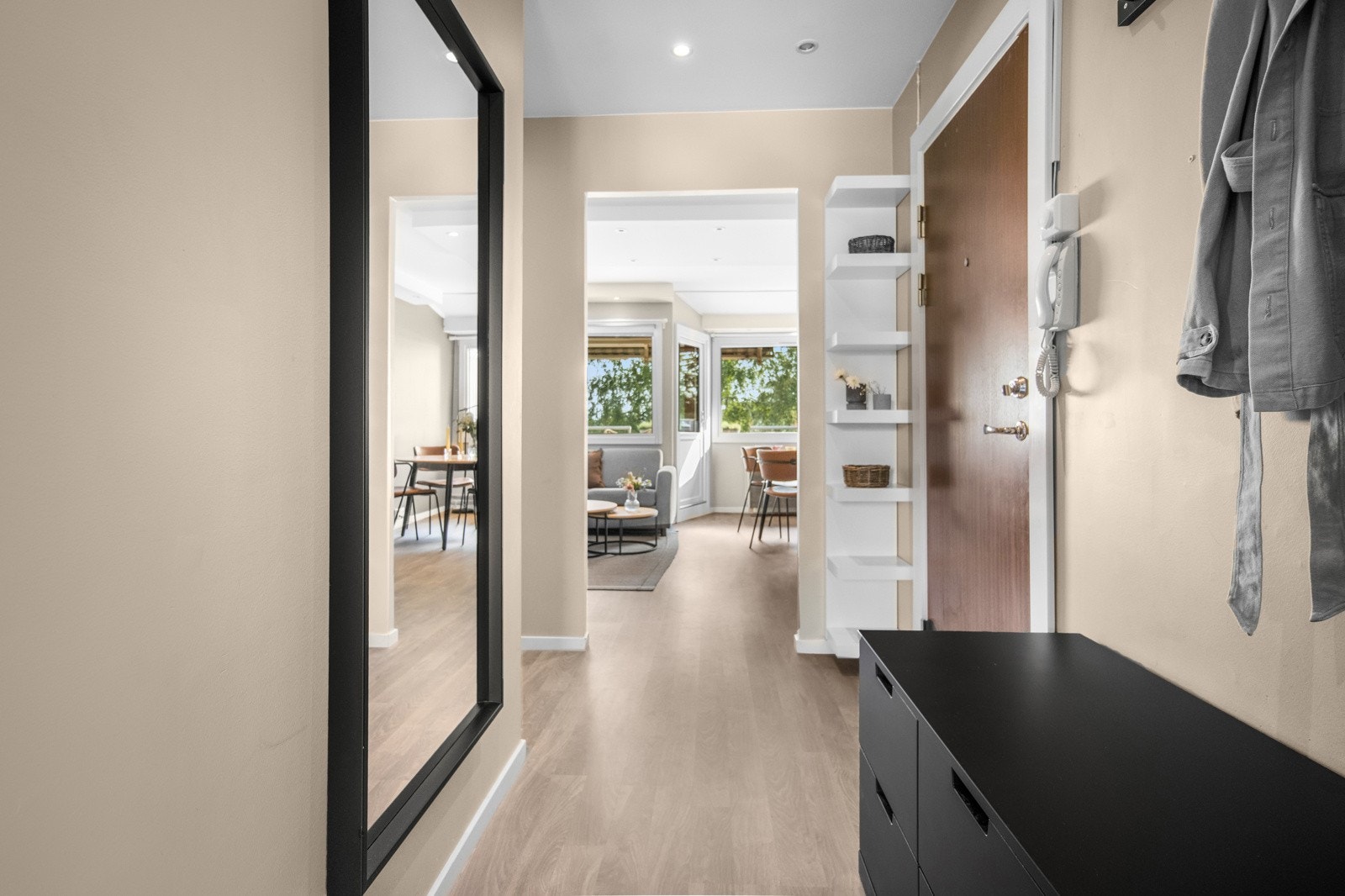 Videre er det en åpen og lys entré med muligheter for oppbevaring via kommoder og oppheng Galleribilde