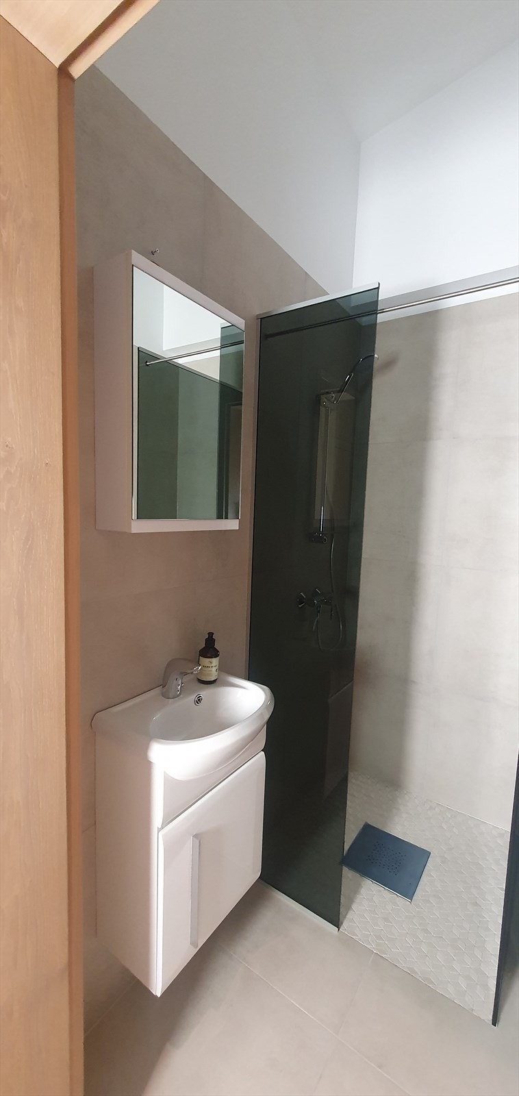 Det pene, flislagte baderommet har lekre fliser på gulv og vegger. Dette gir et moderne og stilrent uttrykk Galleribilde