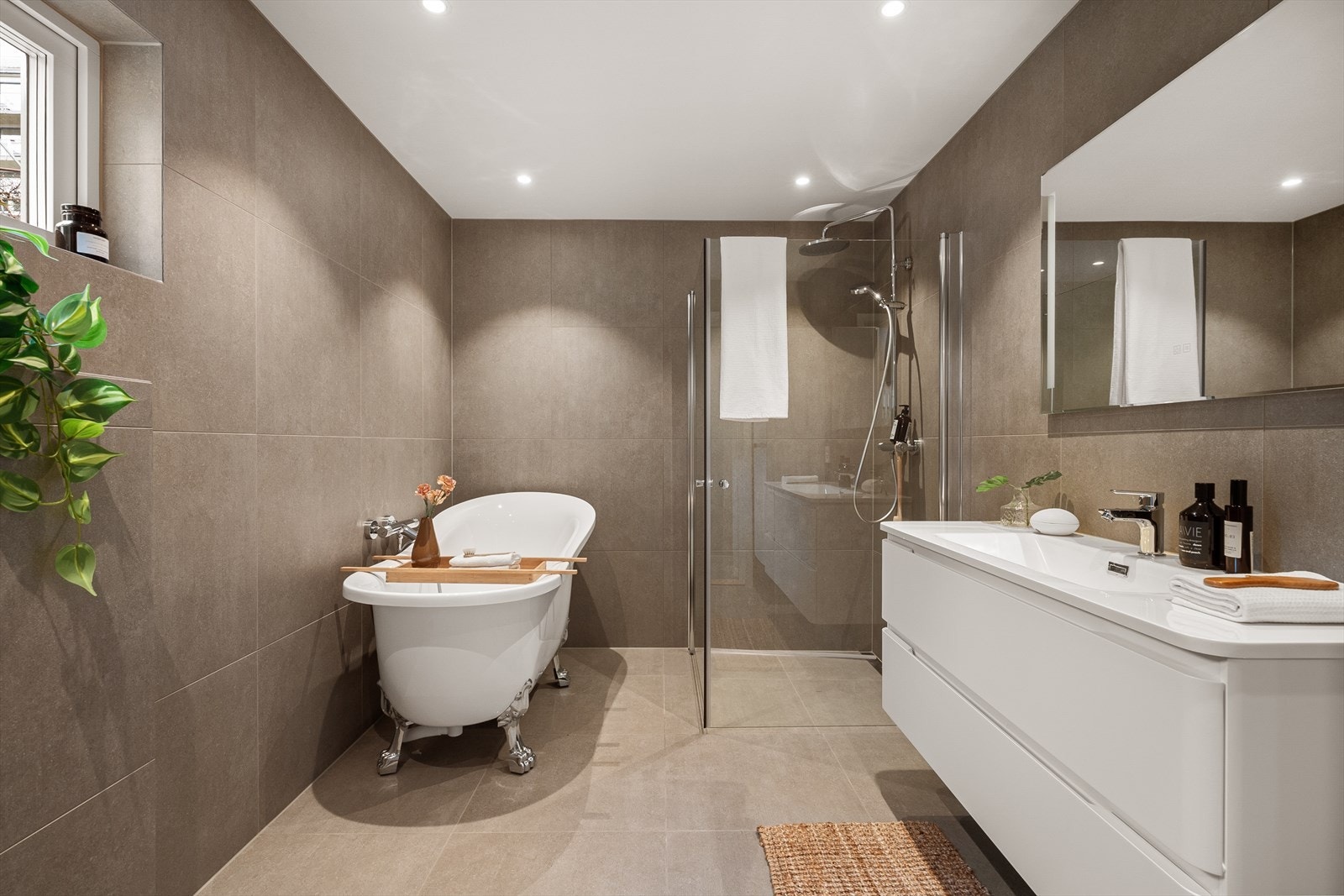 Nytt flislagt bad i 2025 i 1 etasje med dusjhjørne, badekar, veggfestet wc og vask med skuffer Galleribilde