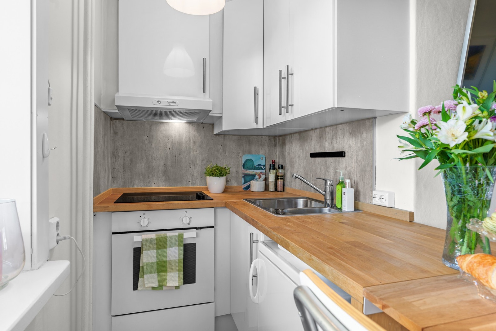 Praktisk kjøkkeninnredning bestående av glatte fronter, benkeplate i finer som nylig er oljet og behandlet. Galleribilde