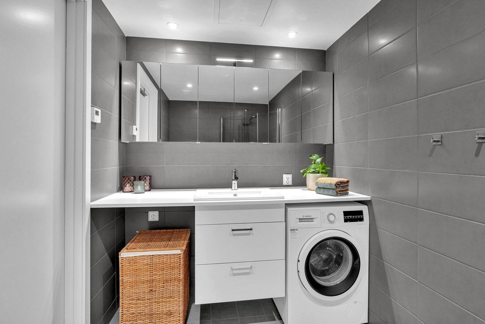 Badet har også vegghengt toalett, dusjhjørne med innfellbare glassdører og opplegg for både vaskemaskin og tørketrommel. Galleribilde