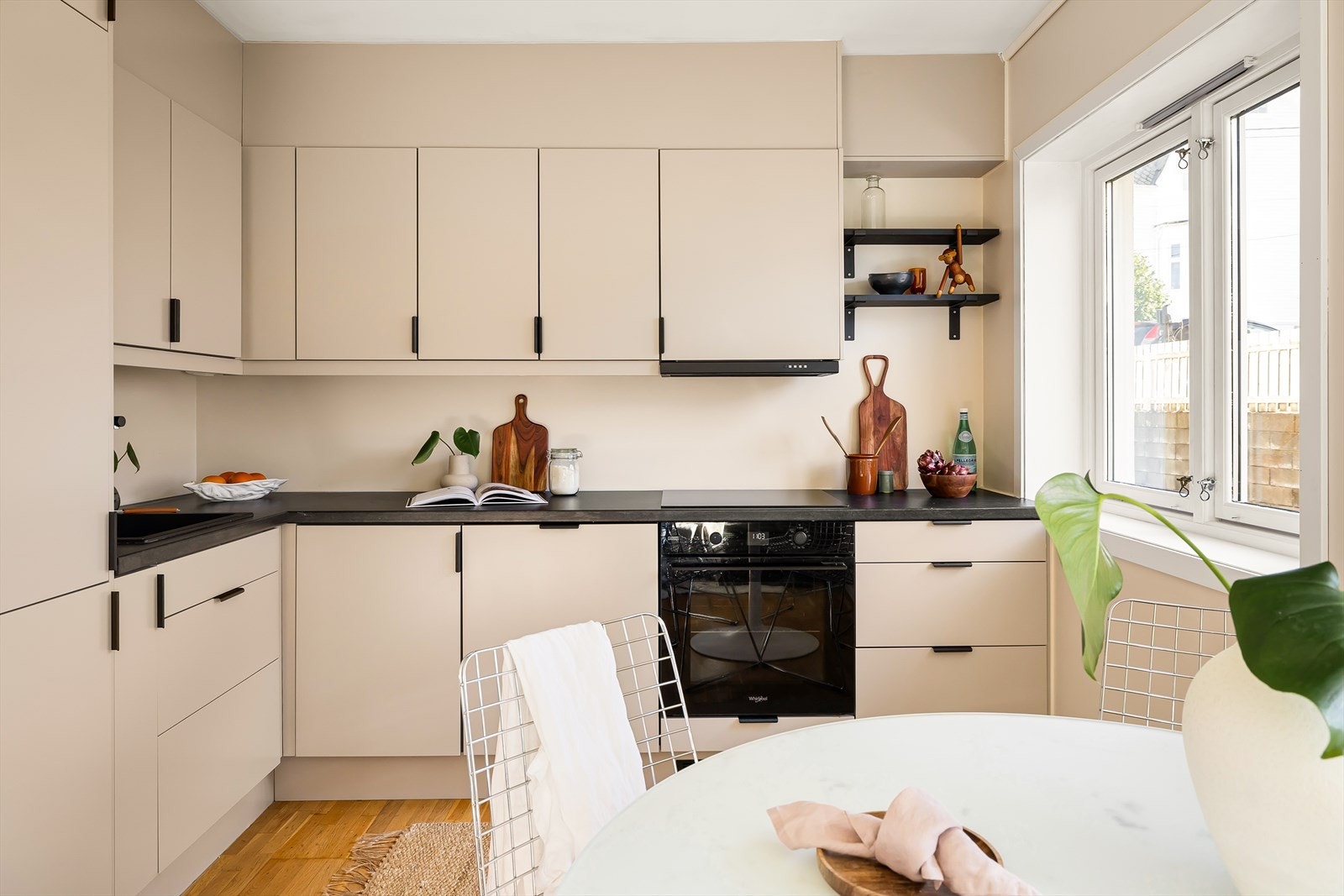 Nytt kjøkken fra 2023 med beige slette fronter, benkeplate i laminat og integrerte hvitevarer. Galleribilde