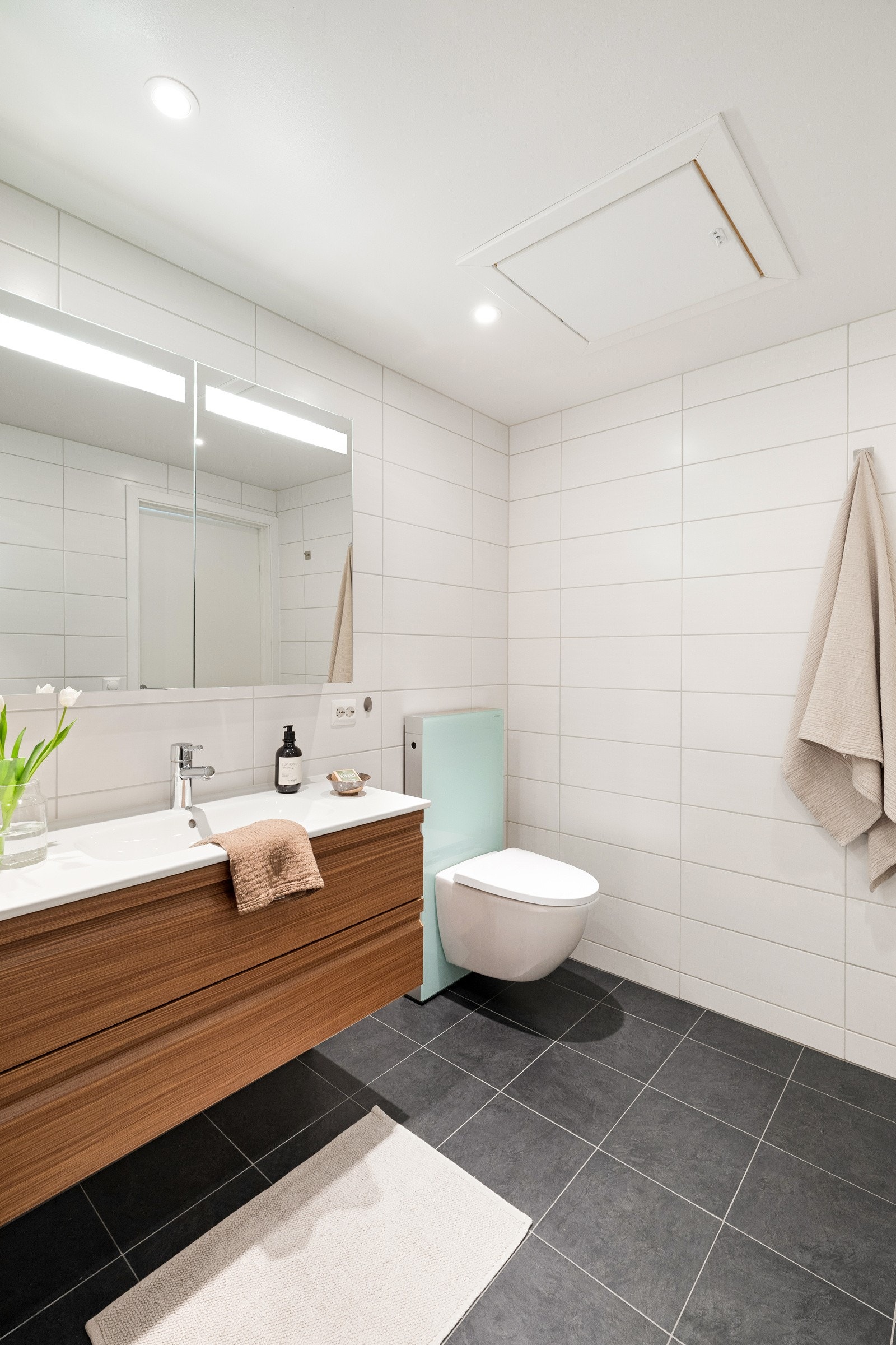 Det består av baderomsmøbel, speil med belysning, vegghengt toalett og dusjhjørne. Vannbåren varme i gulv og spotter i tak. Galleribilde