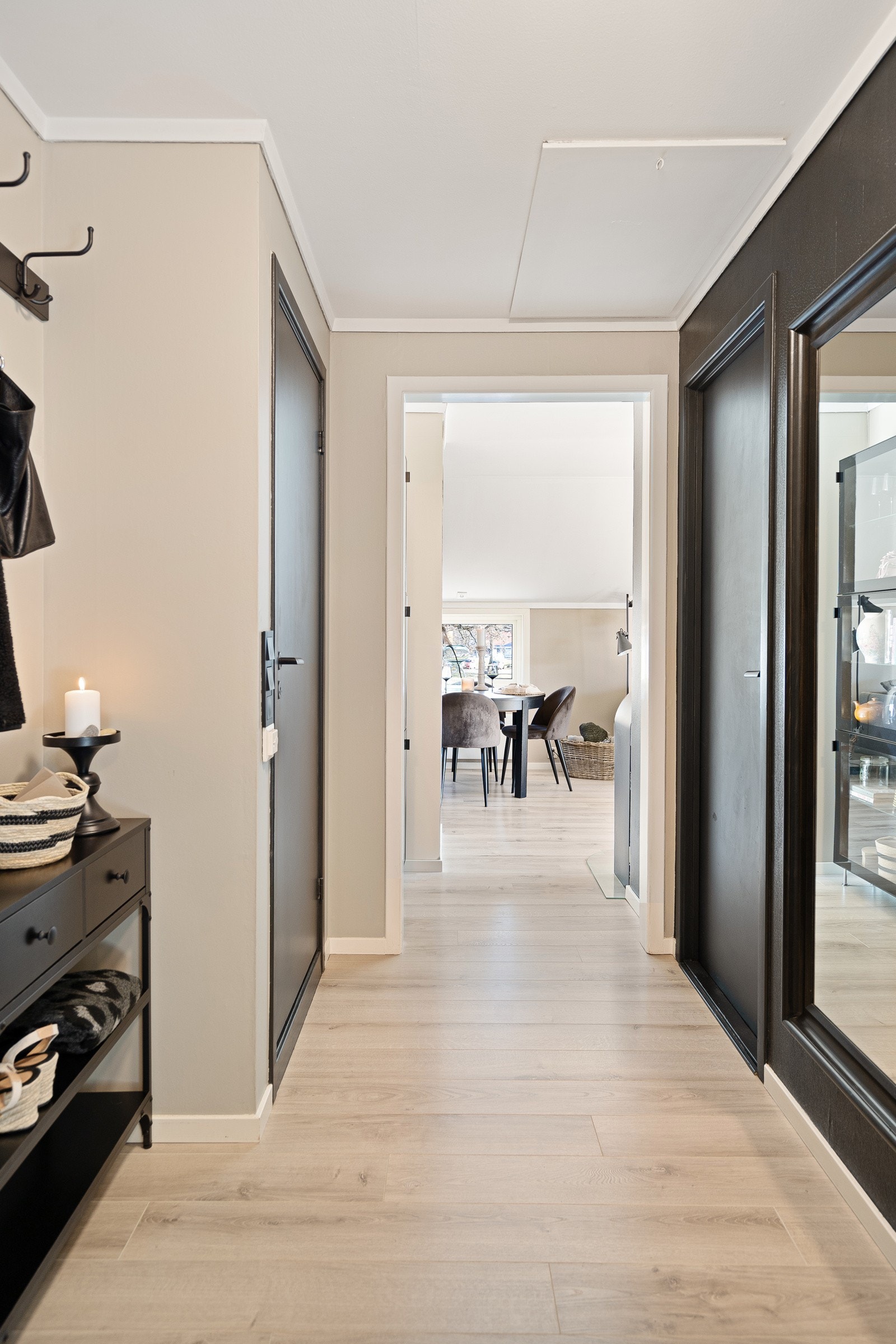 Entreen har også sorte fondvegger, sorte innerdører, samt dørtelefon og inngang til en praktisk bod. Leiligheten har enstavs laminat på alle gulv, glatte veggflater og glatte takflater. Galleribilde