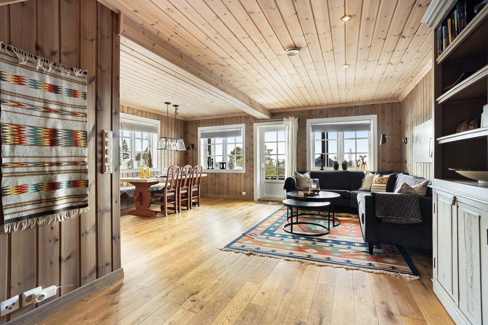 Innbydende og sosial stue i første etasje, med åpen løsning mot kjøkkenet Galleribilde