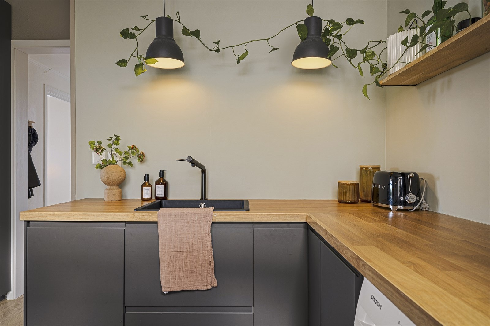 De integrerte hvitevarene, herunder stekeovn, induksjonsplatetopp, oppvaskmaskin, vaskemaskin og kombinert kjøl- og fryseskap, medfølger i handelen. Galleribilde