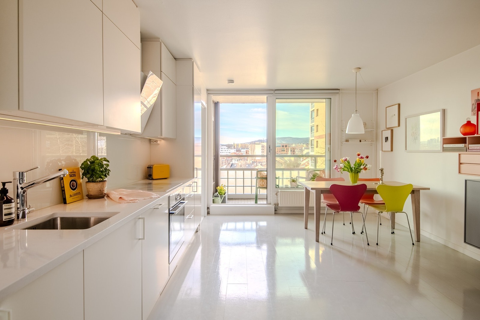 Valg av hvite håndtak kombinert med hvit platetopp, stekeovn og avtrekksvifte, bidrar til et minimalistisk og lite dominerende preg over kjøkkenet. Galleribilde