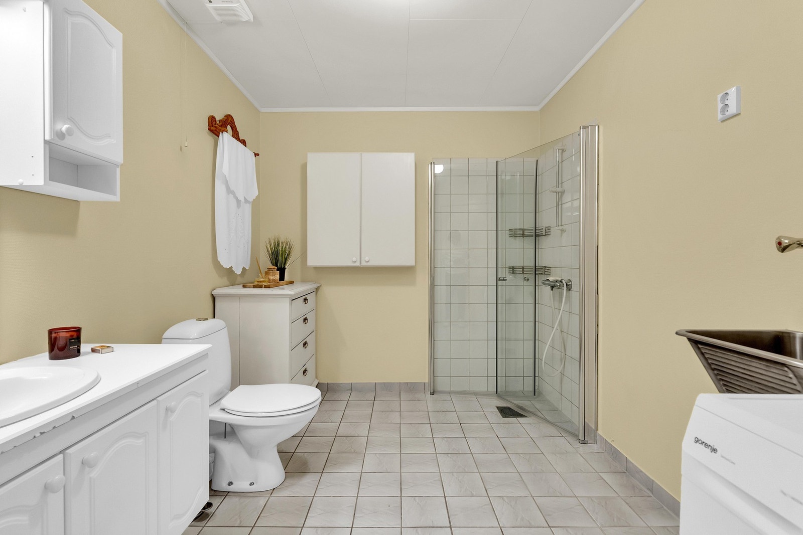 Her er det også vegghengt servantskap med nedfelt servant og ett-greps armatur, samt overskap og speil med overlys på vegg over servant. Videre er det en dusjnisje med innfellbare glassdører fra 2024, dusjarmatur og gulvmontert toalett. Det er også utslag Galleribilde