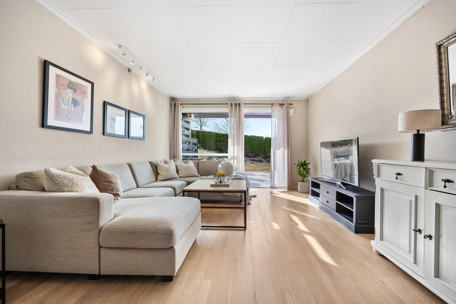 I det du går inn i stuen legger du fort merke til de store vindusflatene som slipper inn masse dagslys. Dette gir stuen en luftig atmosfære som skaper trivsel sammen med de delikate fargene. Galleribilde