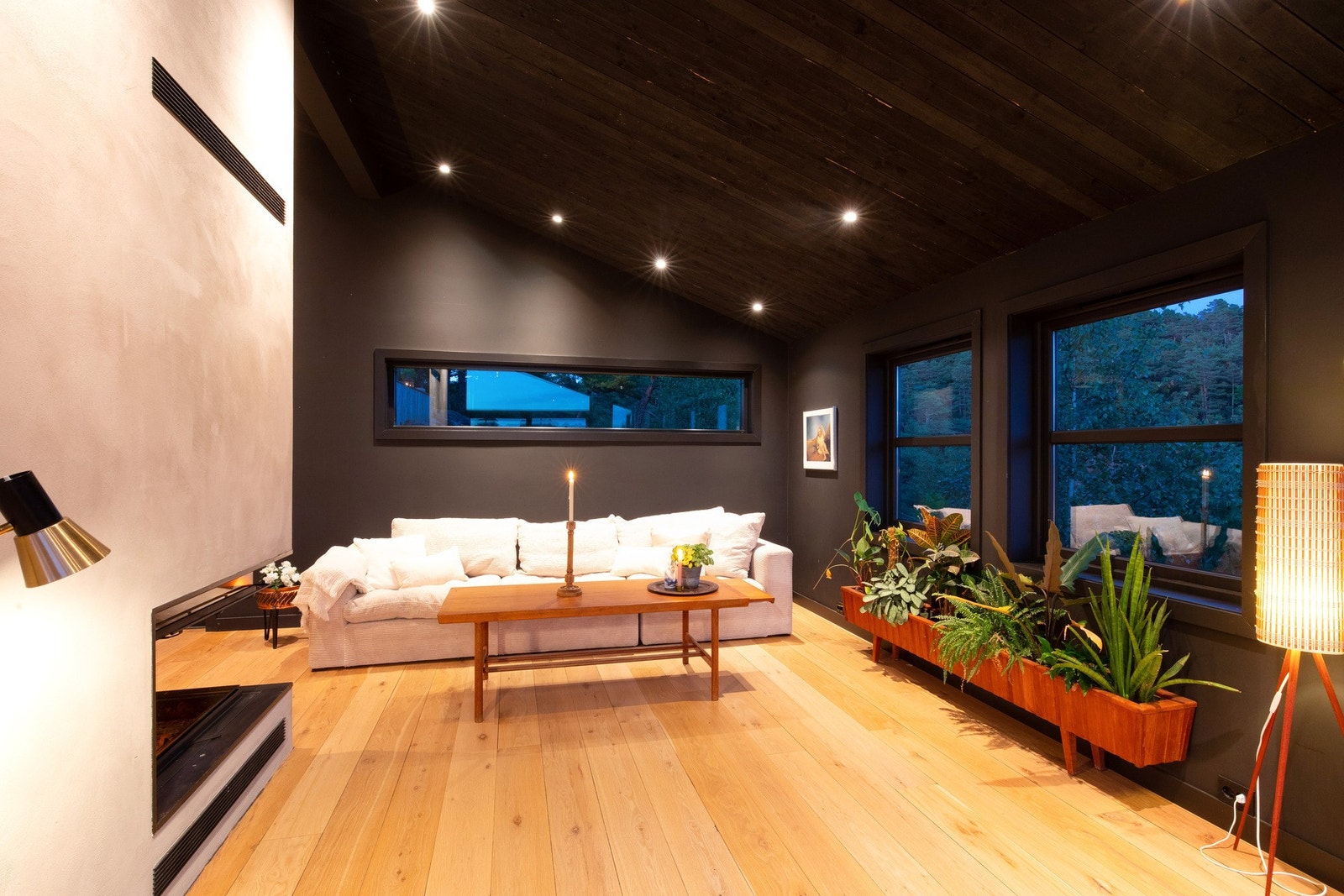 Gulvflaten i stue/kjøkken, i heltre eik, skaper en lun atmosfære. Legg merke til peisen med hev-/senk front i herdet glass. Galleribilde