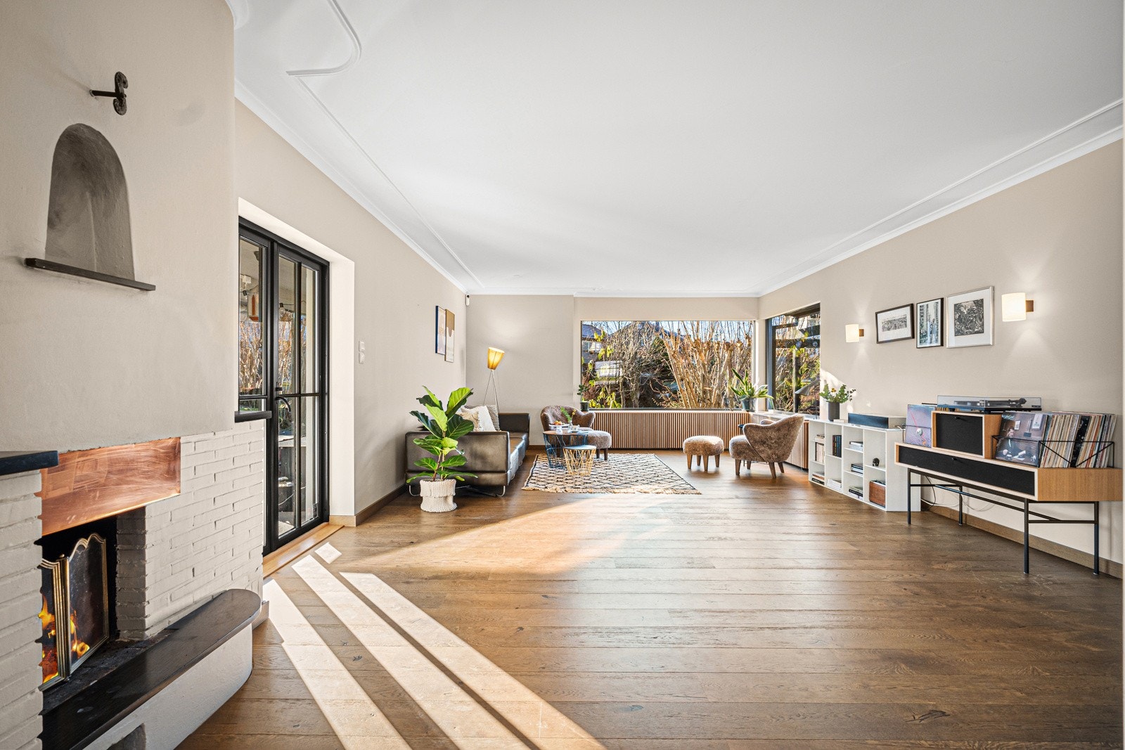 Stue vendt mot vest hvor lyset flommer inn de store vindusflatene Galleribilde