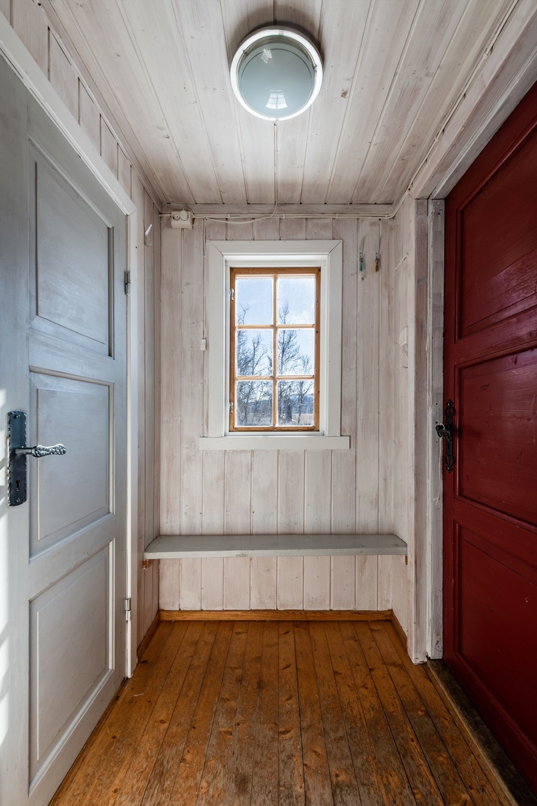 Vindfang: Lakket tregulv og beiset trepanel på vegger. Galleribilde