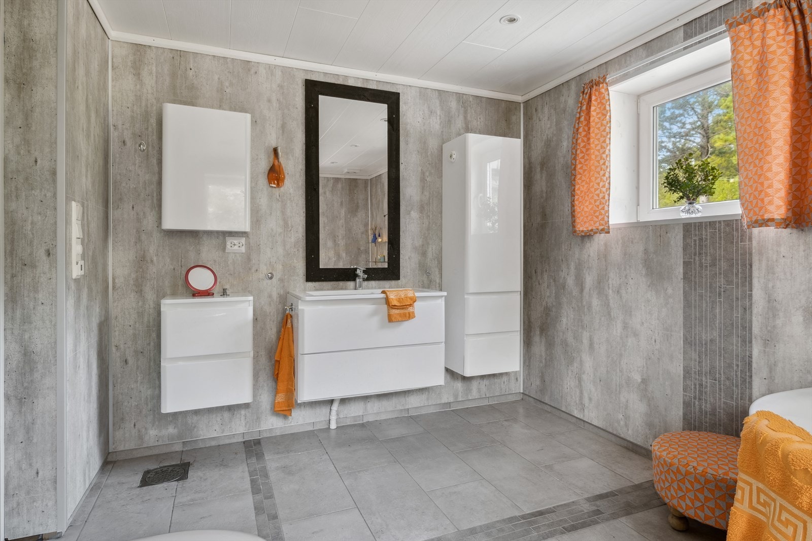 Innredningen består blant annet av badekar, dusjkabinett og vegghengt klosett. Galleribilde