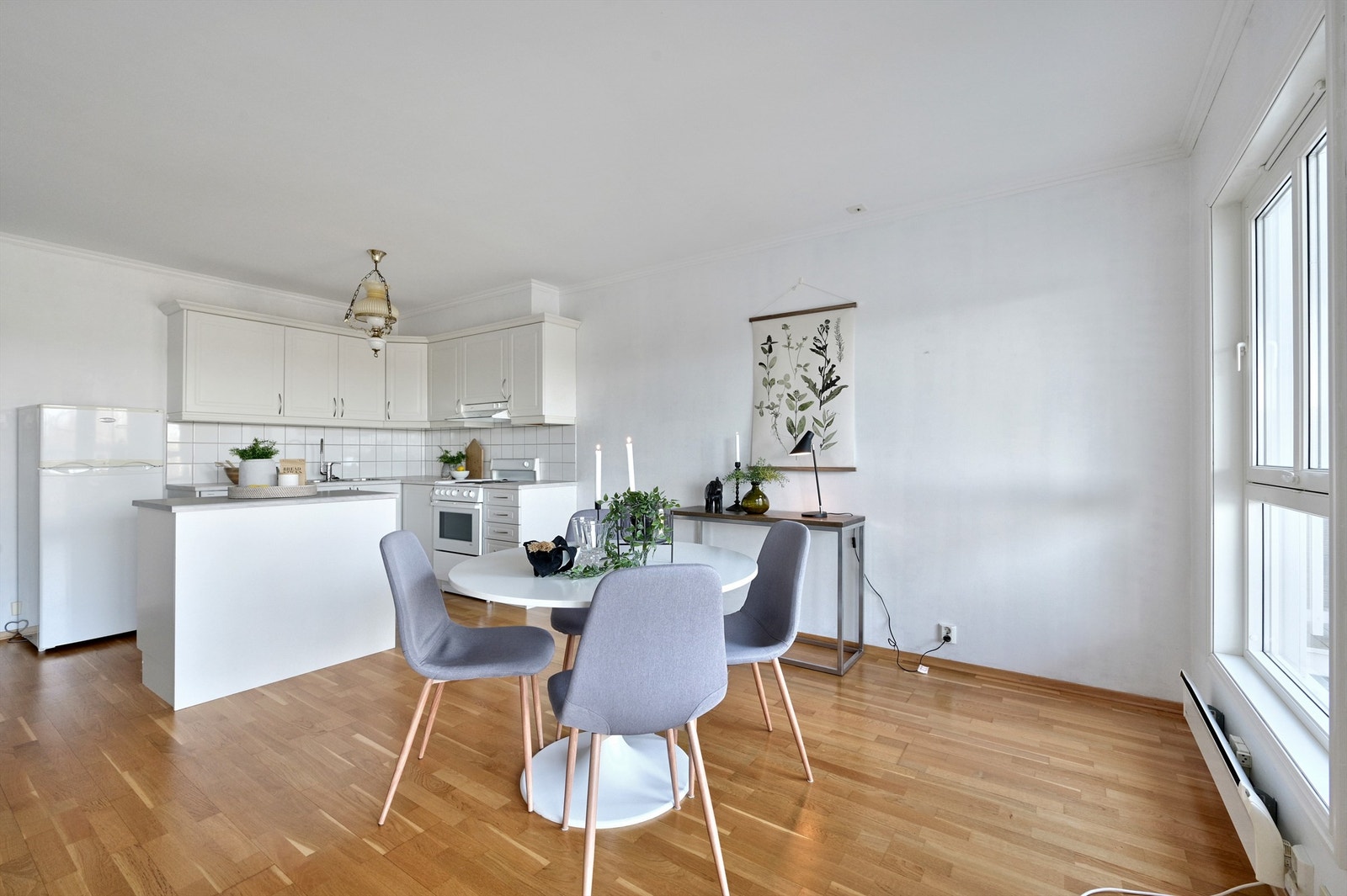 Lyst kjøkken med øy og plass til spisemøbler Galleribilde