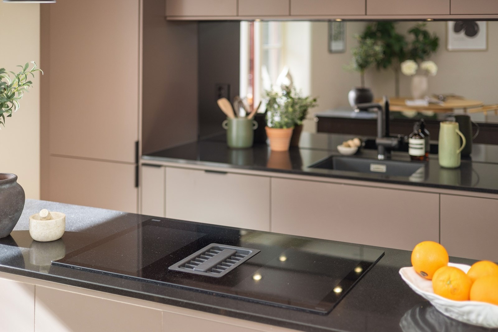 Det er kjøkkenventilator med kullfilter integrert i platetoppen. Galleribilde