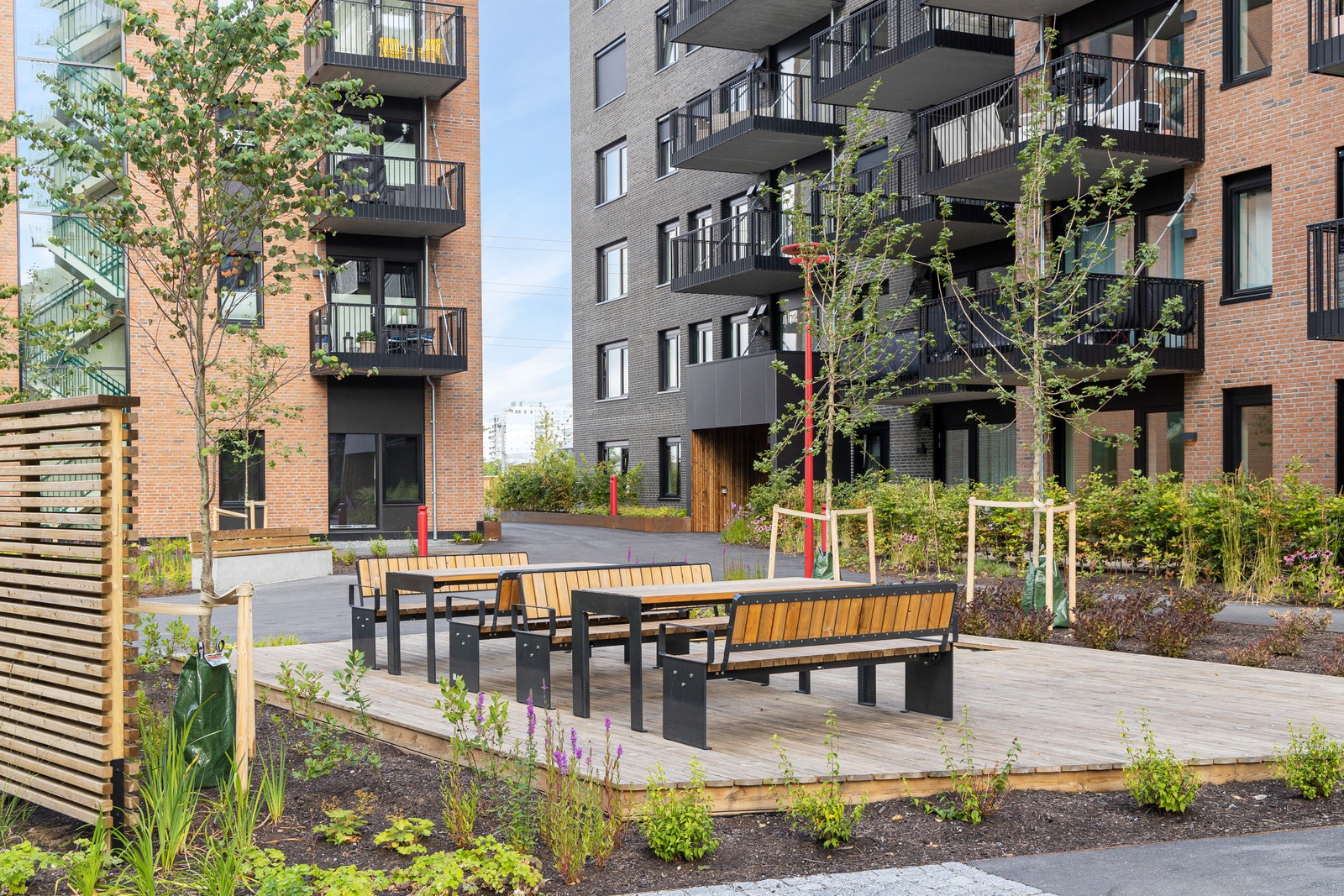 Uteområde med sitteplasser og beplantning Galleribilde
