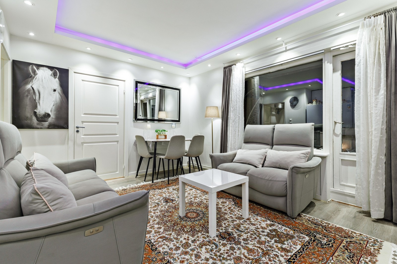 Stuen har store vinduer som slipper inn rikelig med naturlig lys. Galleribilde