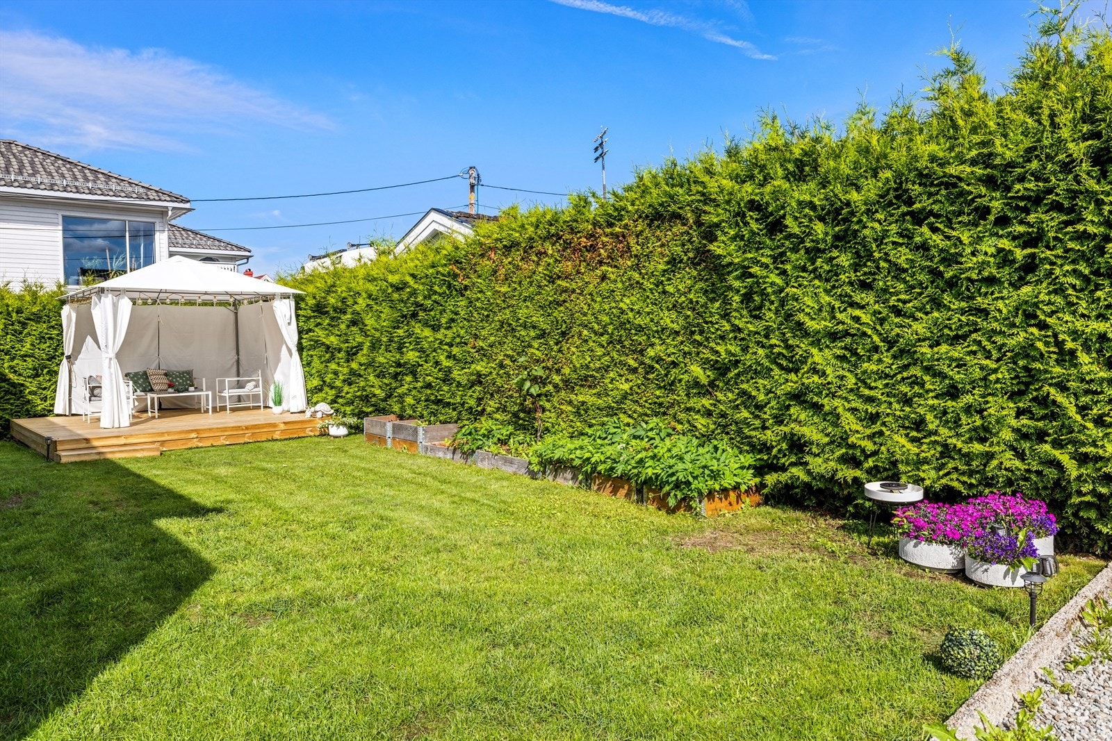 Boligen har en trivelig og barnevennlig hage med fine plenområder, omkranset av skjermende hekk. Galleribilde