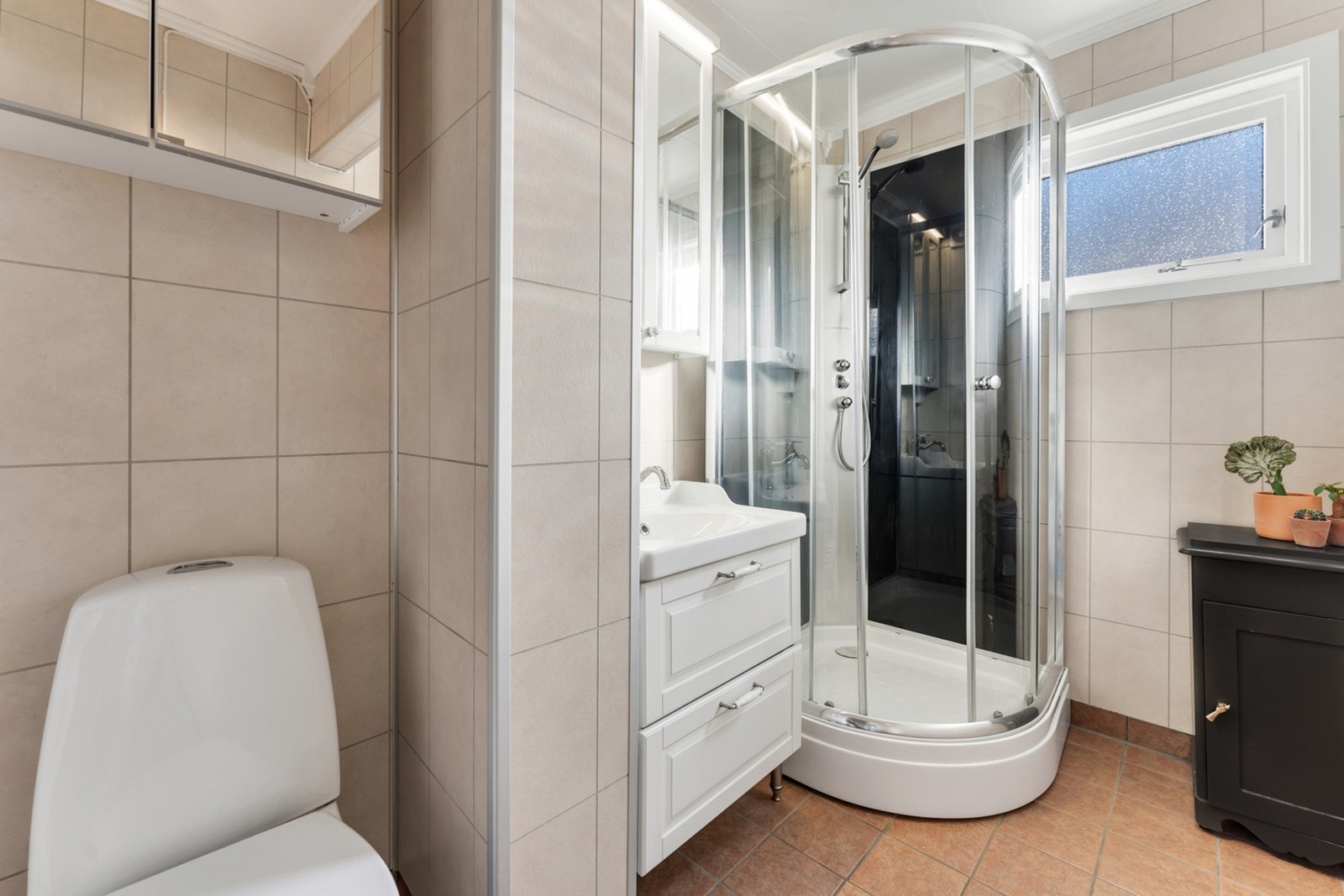 Badet er flislagt på gulv med gulvvarme og baderomsplater på veggene Galleribilde