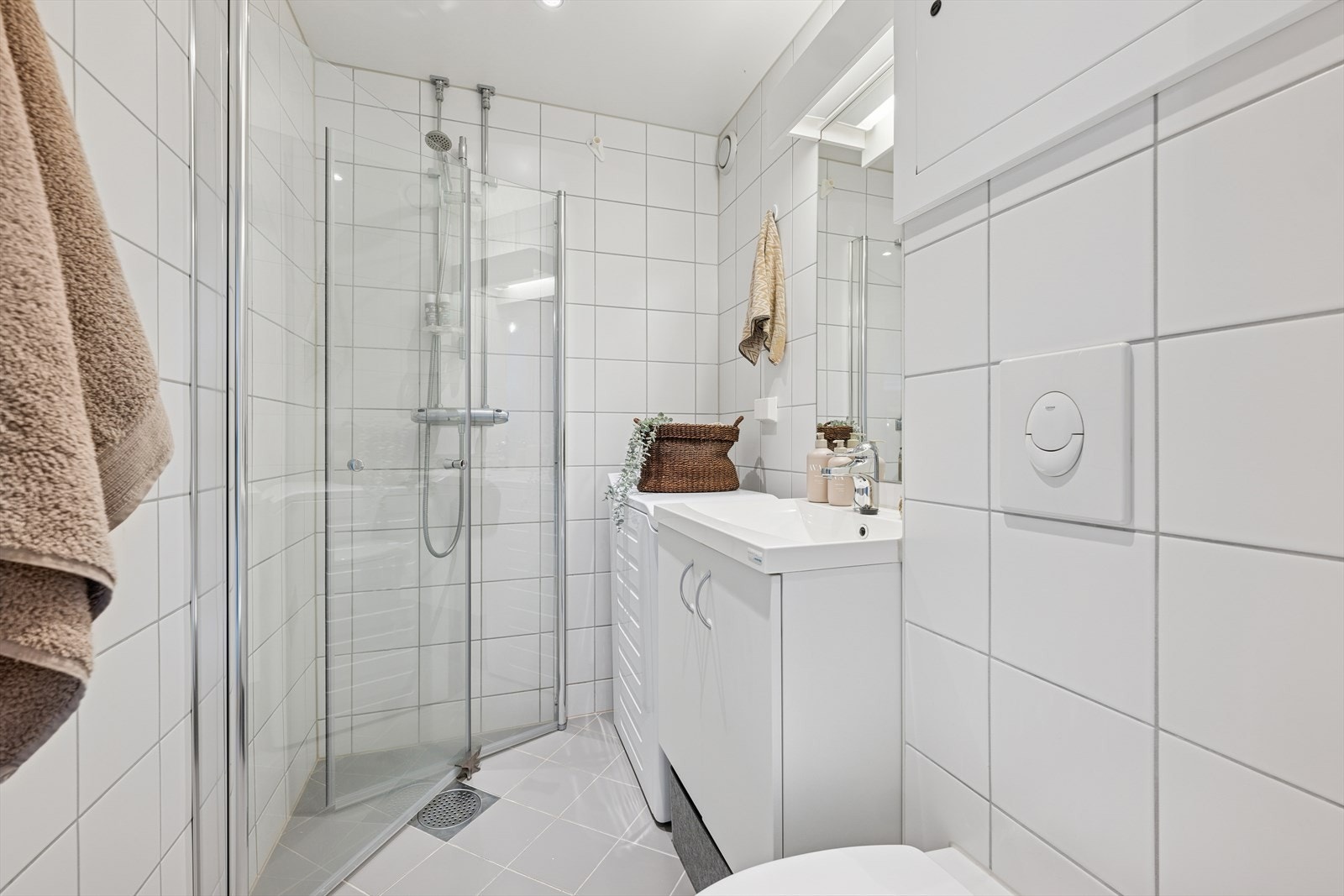 Pent, flislagt baderom med varmekabler og opplegg for vaskemaskin. Galleribilde