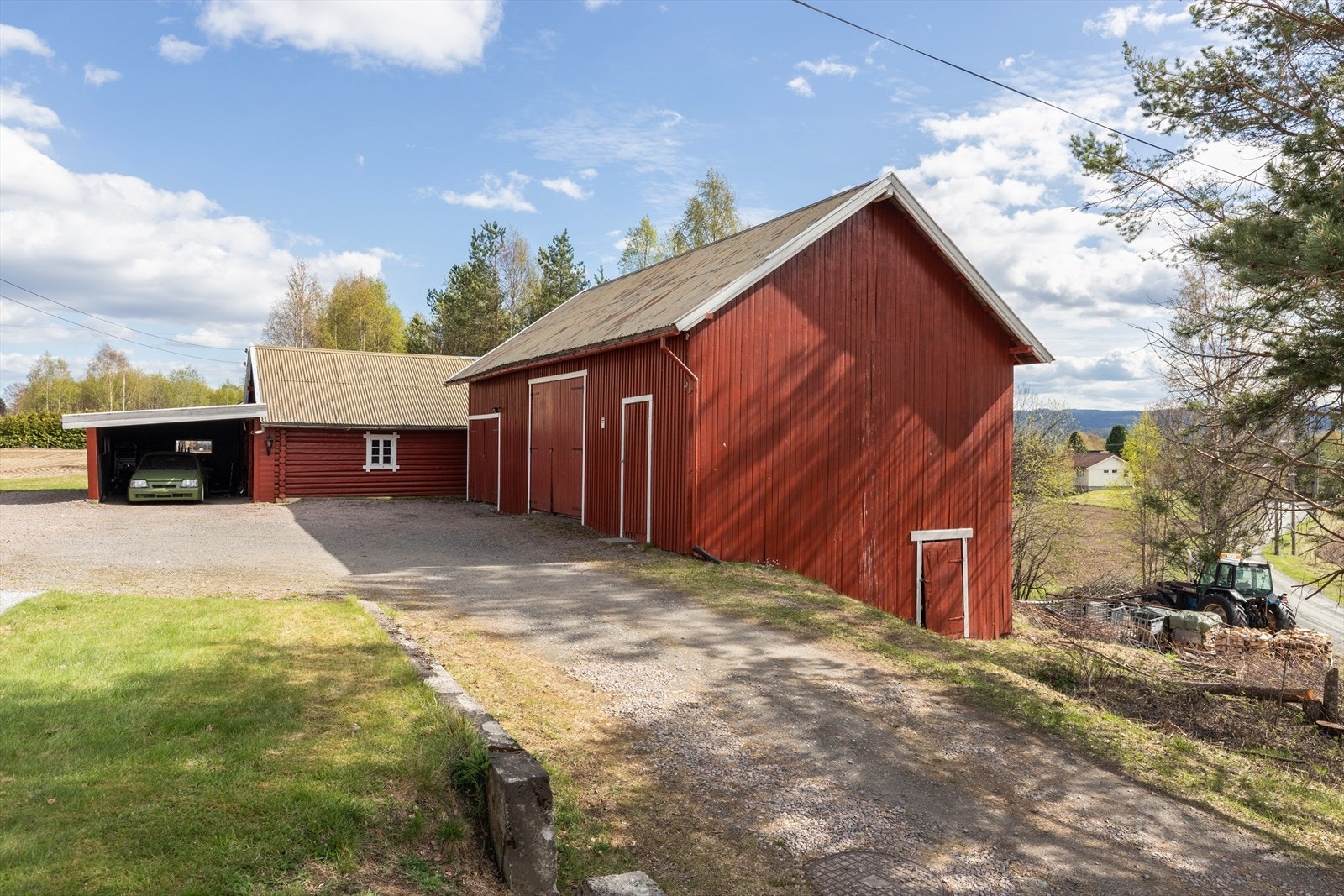 Stor låve fra ca. 1950 med som består av garasje, 4 lagerrom, vedskjul og utedo. Inntilbygget carport på ca. 28m². Galleribilde
