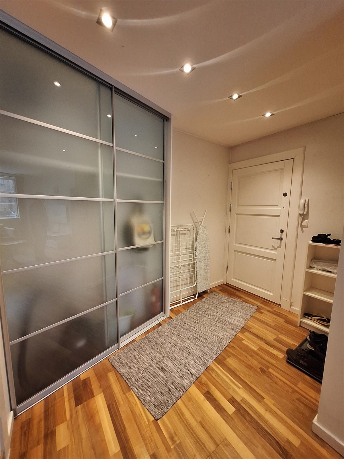 Romslig entré med stort praktisk skyvedørsgarderobe Galleribilde