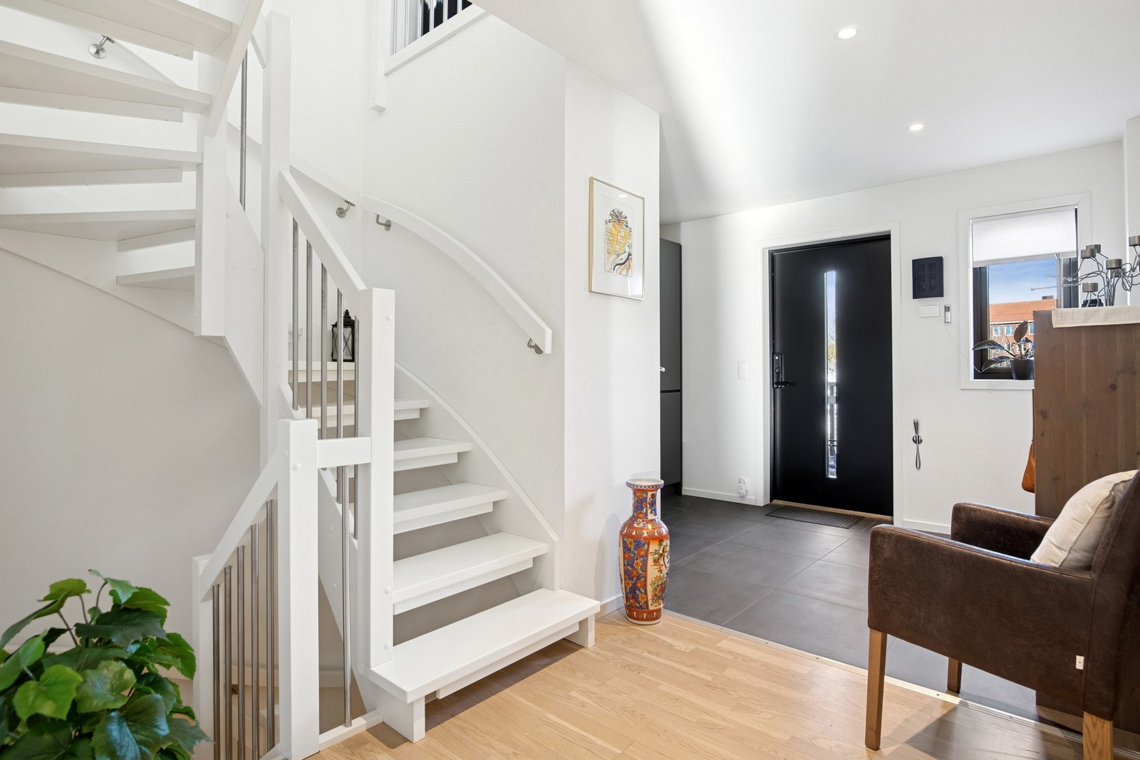 Praktisk flislagt gang med gulvvarme for av og påkledning. Det er garderobeskap til sko og yttertøy. Galleribilde