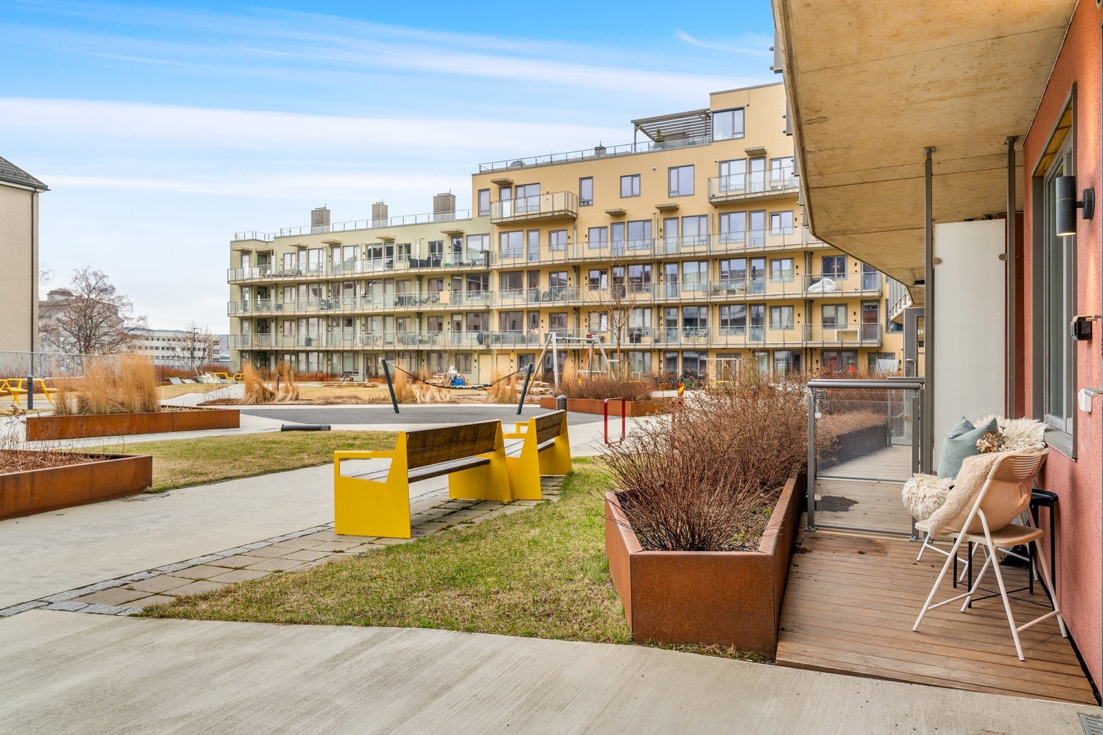 Leiligheten har en tilbaketrukket og fin beliggenhet på bakkeplan vendt ut mot sameiets fellesareal. Ved inngangspartiet disponerer man en sørvendt markterrasse med plass til et kafésett med bord og stoler. Galleribilde