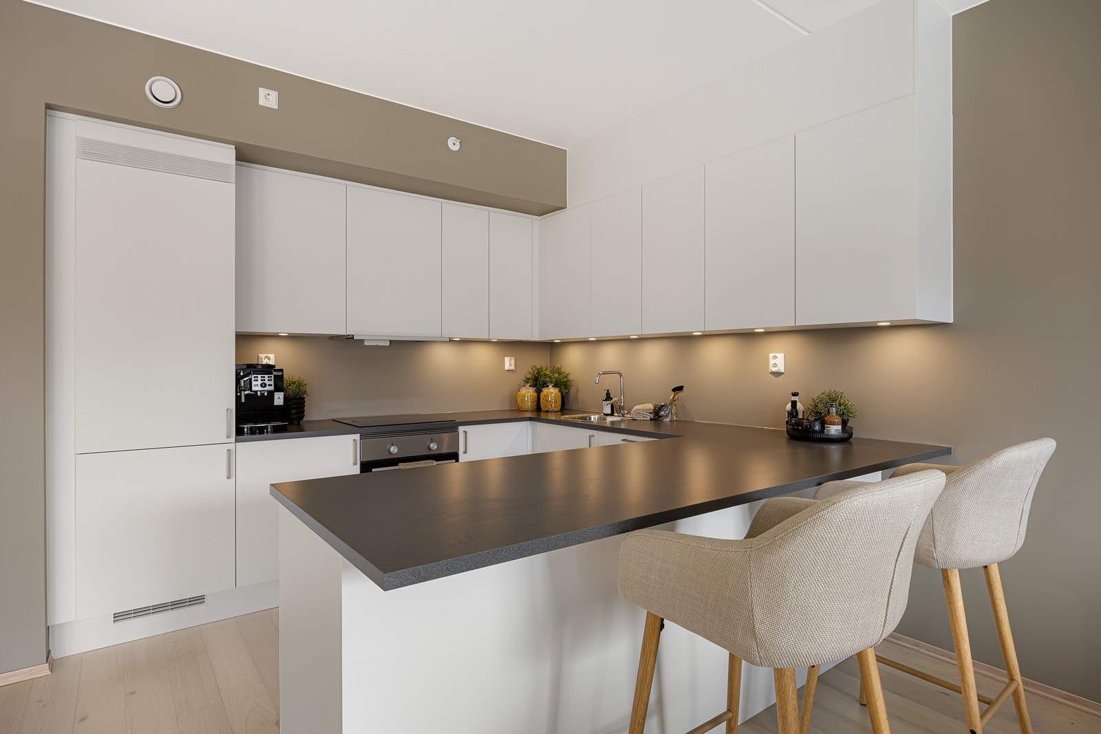 Kjøkkenet har en smart barløsning, slik at man kan ha det sosialt under matlagingen Galleribilde