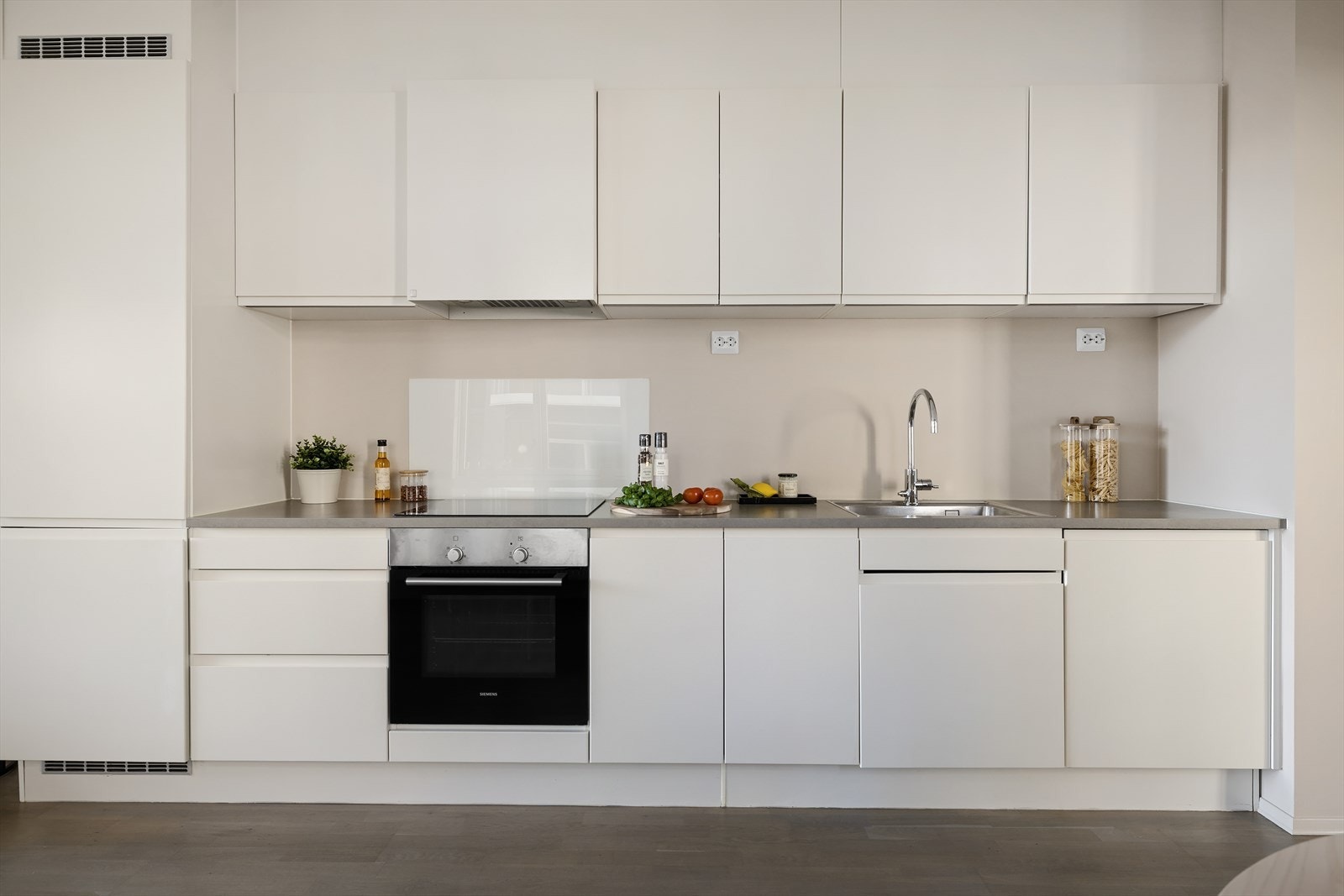 Moderne HTH kjøkken med integrerte hvitevarer og gode oppbevaringsmuligheter Galleribilde