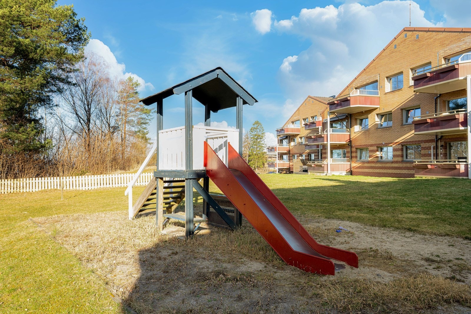 Tomten er pent opparbeidet med plenareal og lekeplass for barna. Galleribilde